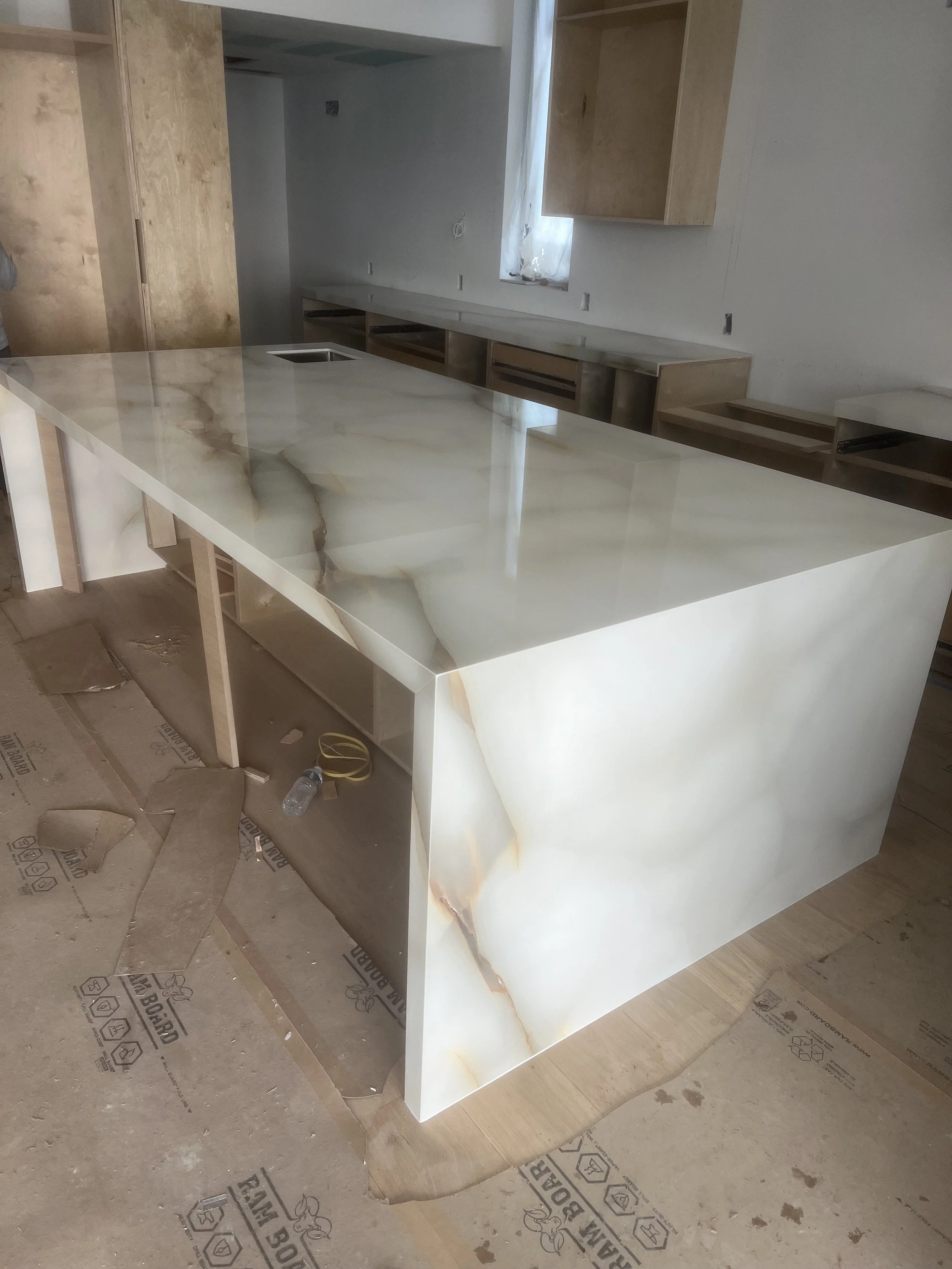 [kitchen-remodeling] Onyx waterfall island installed during construction in a Santa Monica home