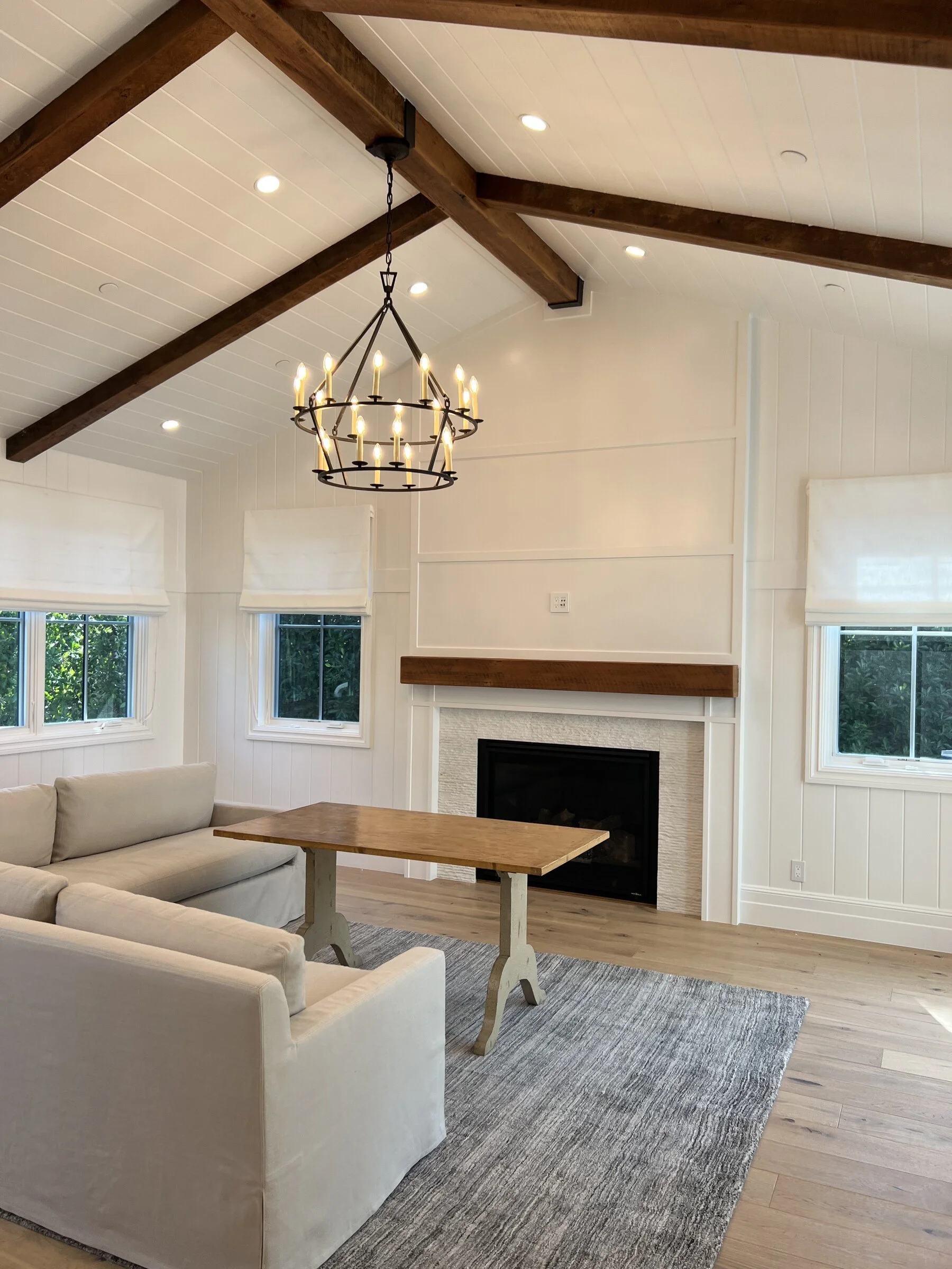 farmhouse-living-room-beamed-ceiling-fireplace-los-angeles.jpg