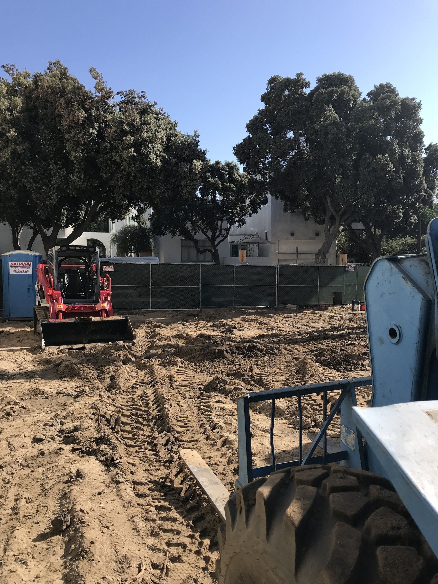 [new-construction] Compact track loader grading a construction site in Santa Monica