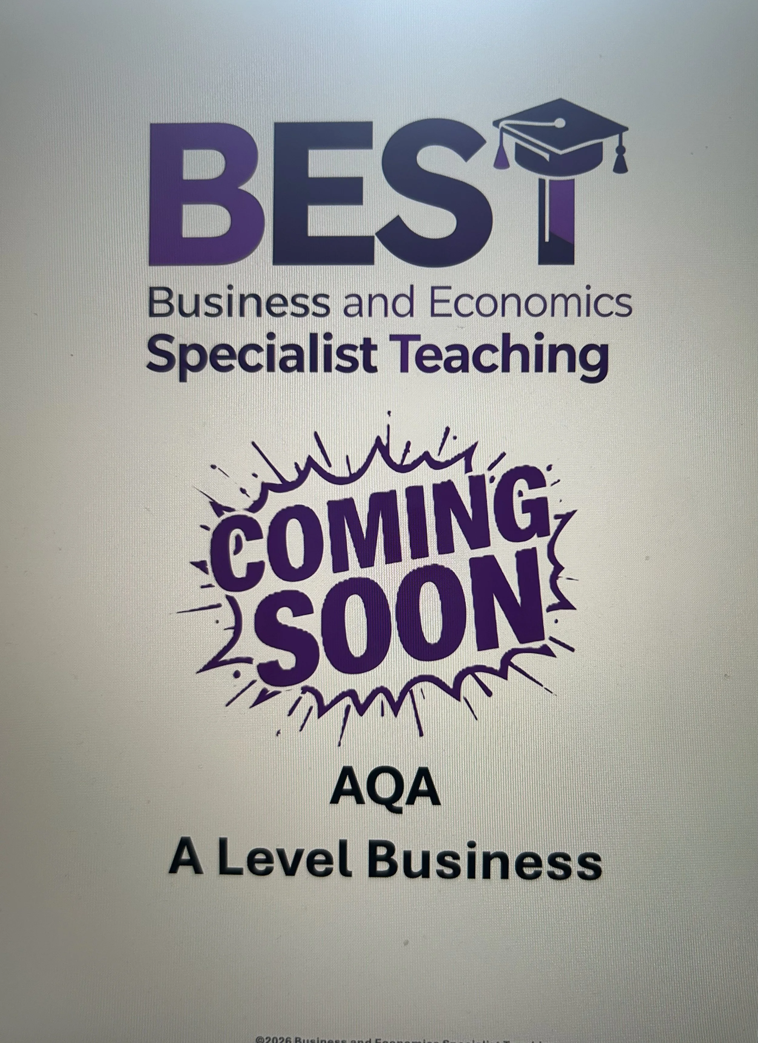 Logo for Business and Economics Specialist Teaching, with an academic cap on the letter T and purple and black text.