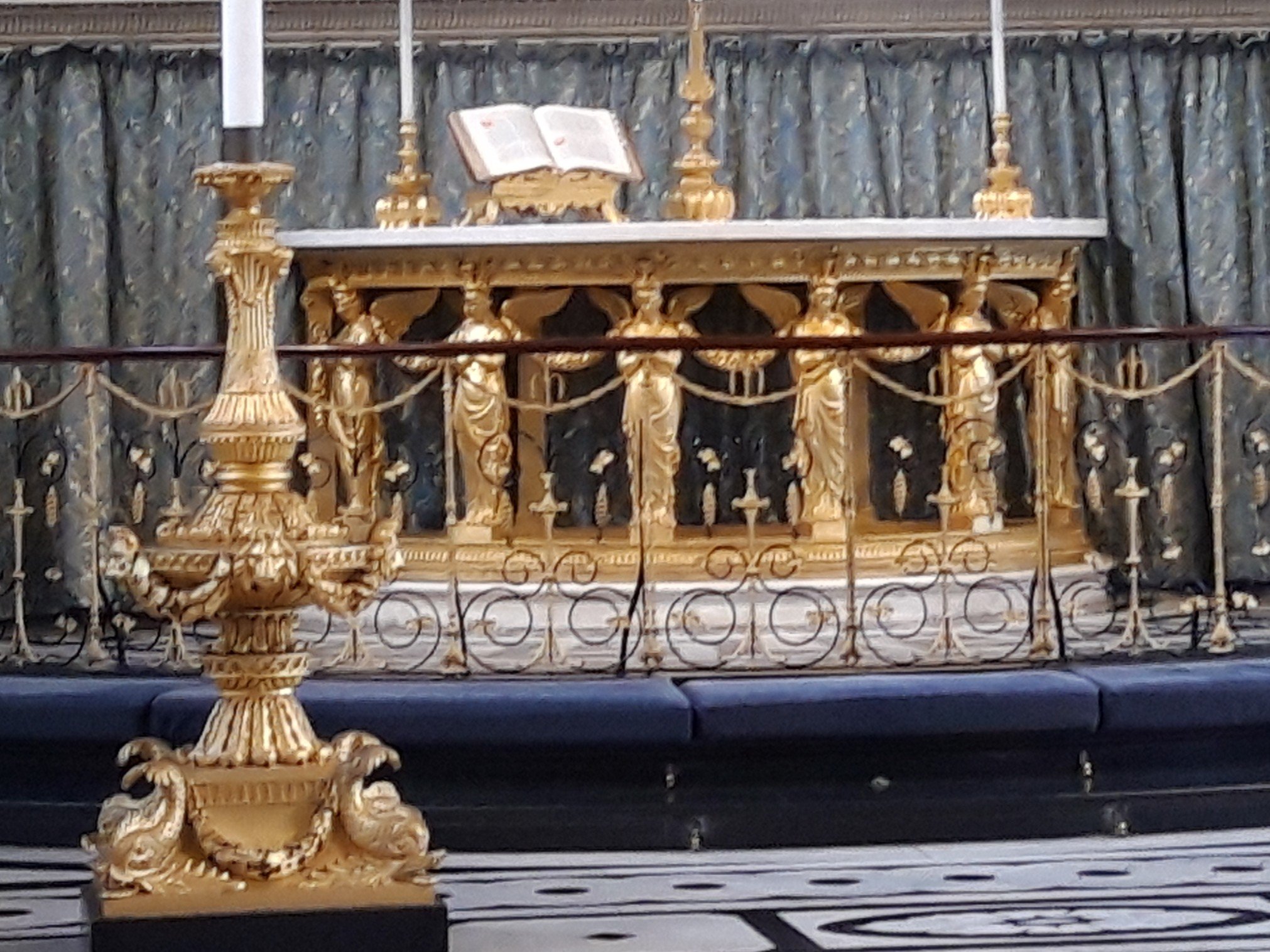 Guilded Coade stone angels supporting an altar.