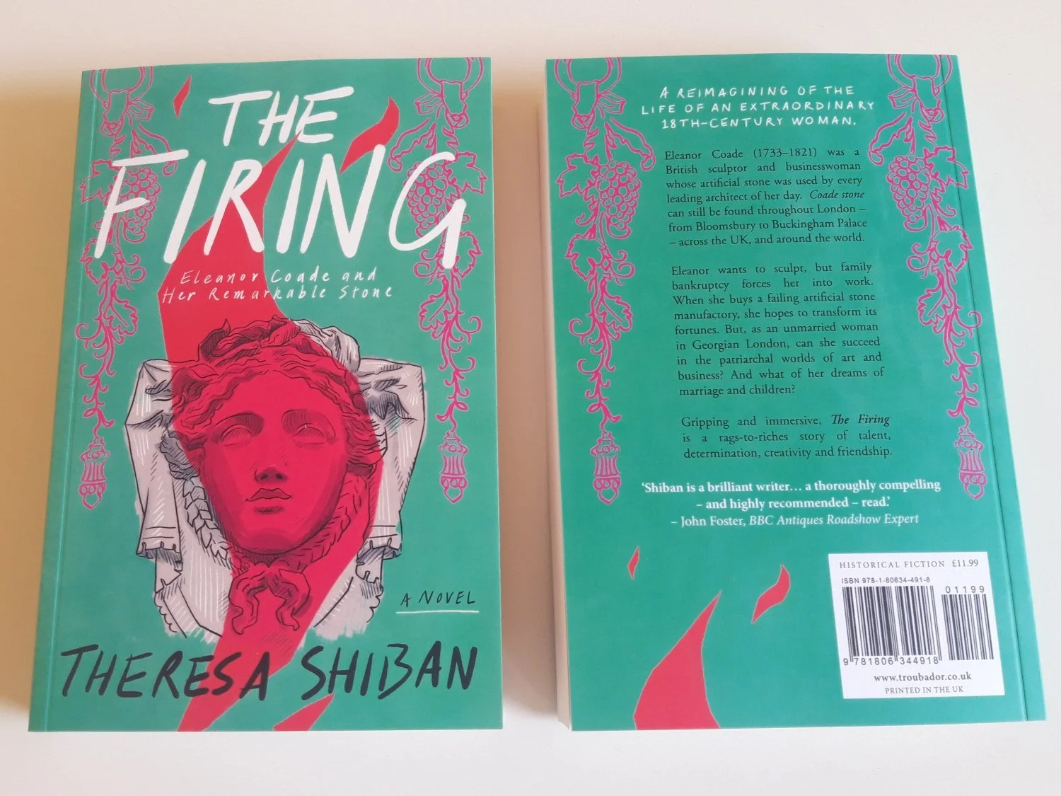'The Firing' by Theresa Shiban: two copies of the book on a table, showing its front and back.