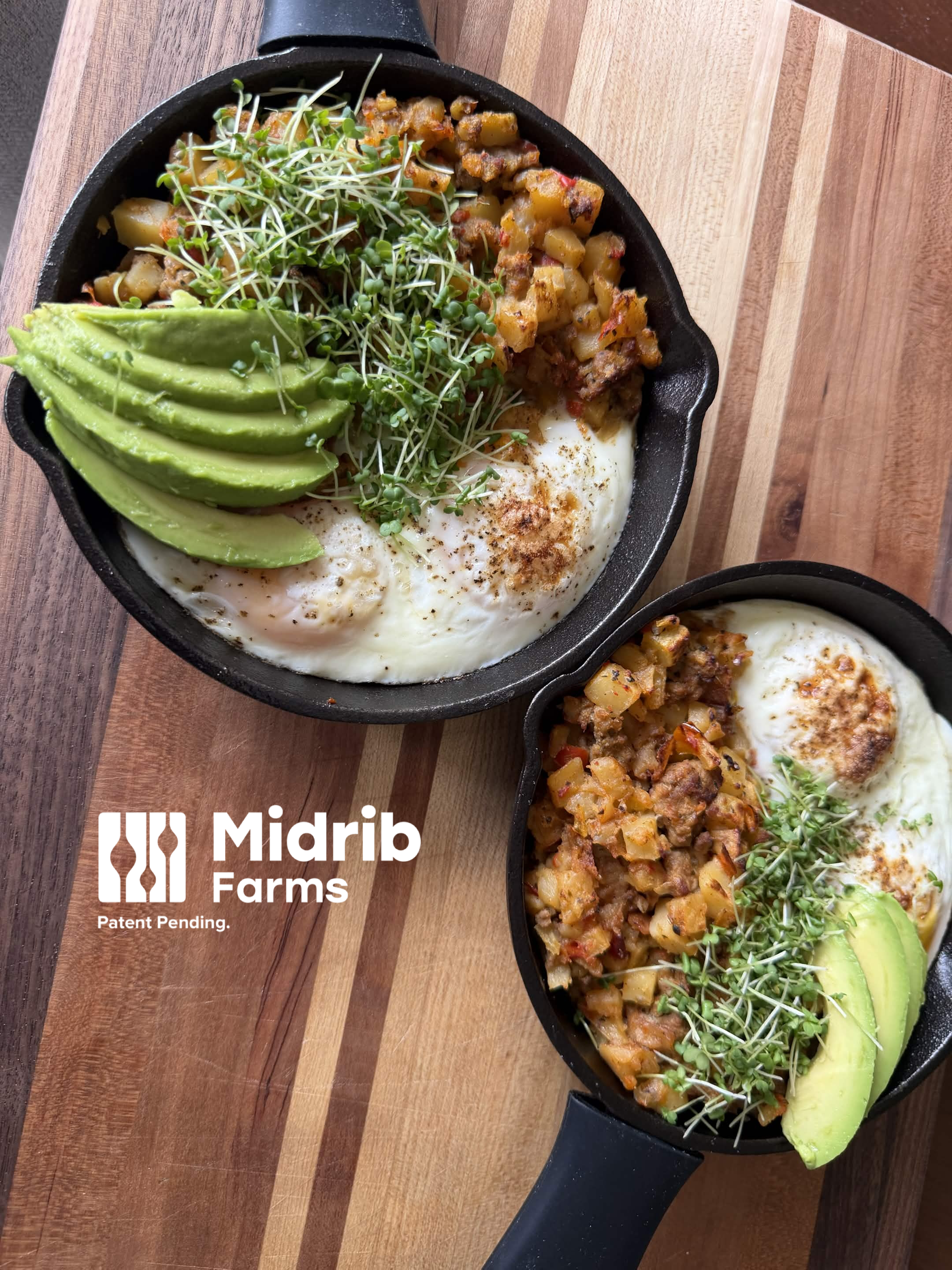 Cast iron skillet with cooked breakfast: sunny side up egg, sliced avocado, microgreens, and seasoned diced potatoes, on a wooden surface.