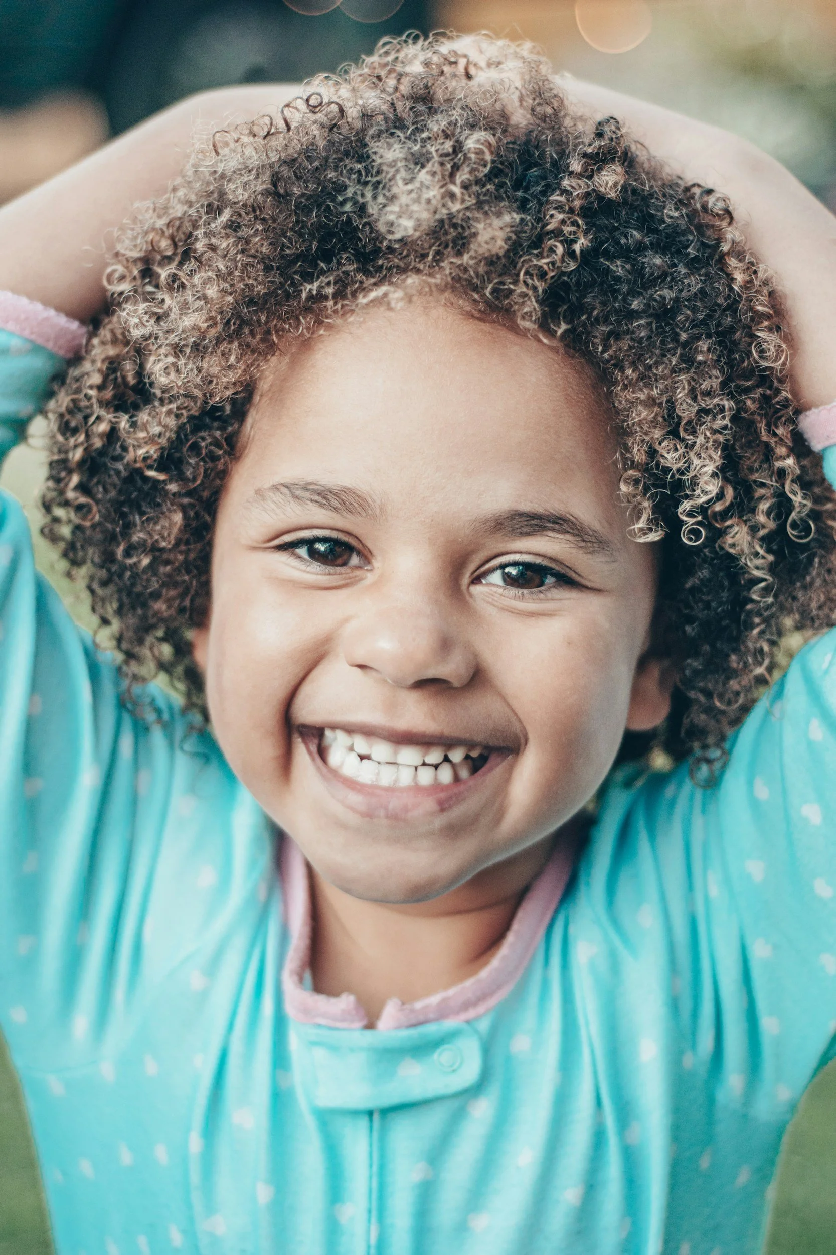 Smiling young child, representing pediatric wellness care for kids ages 0-21 at Moms & Minis Wellness Co.