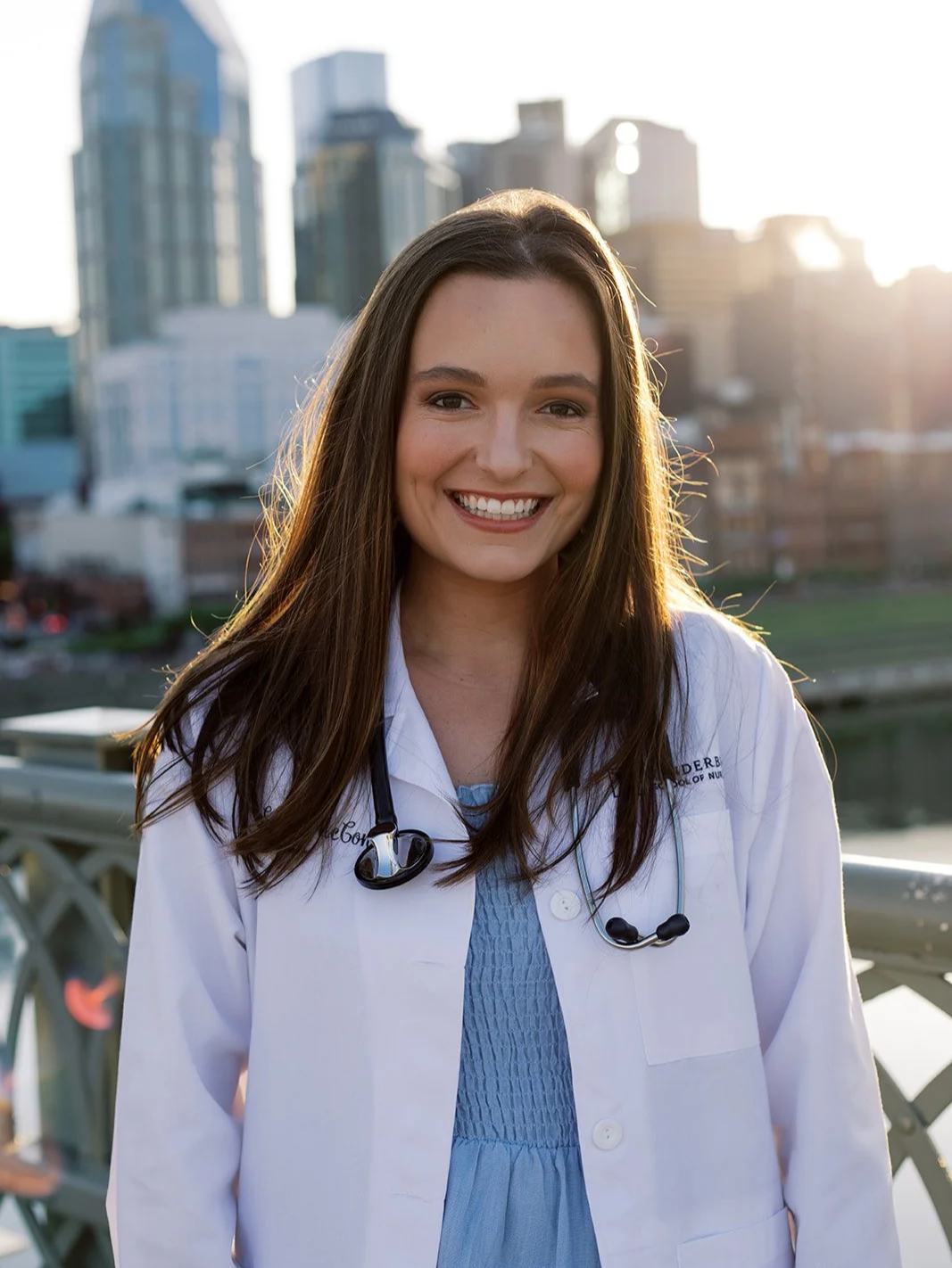 Emily Armstrong, pediatric provider at Moms & Minis Wellness Co. in Brevard County, Fl, wearing a white coat.