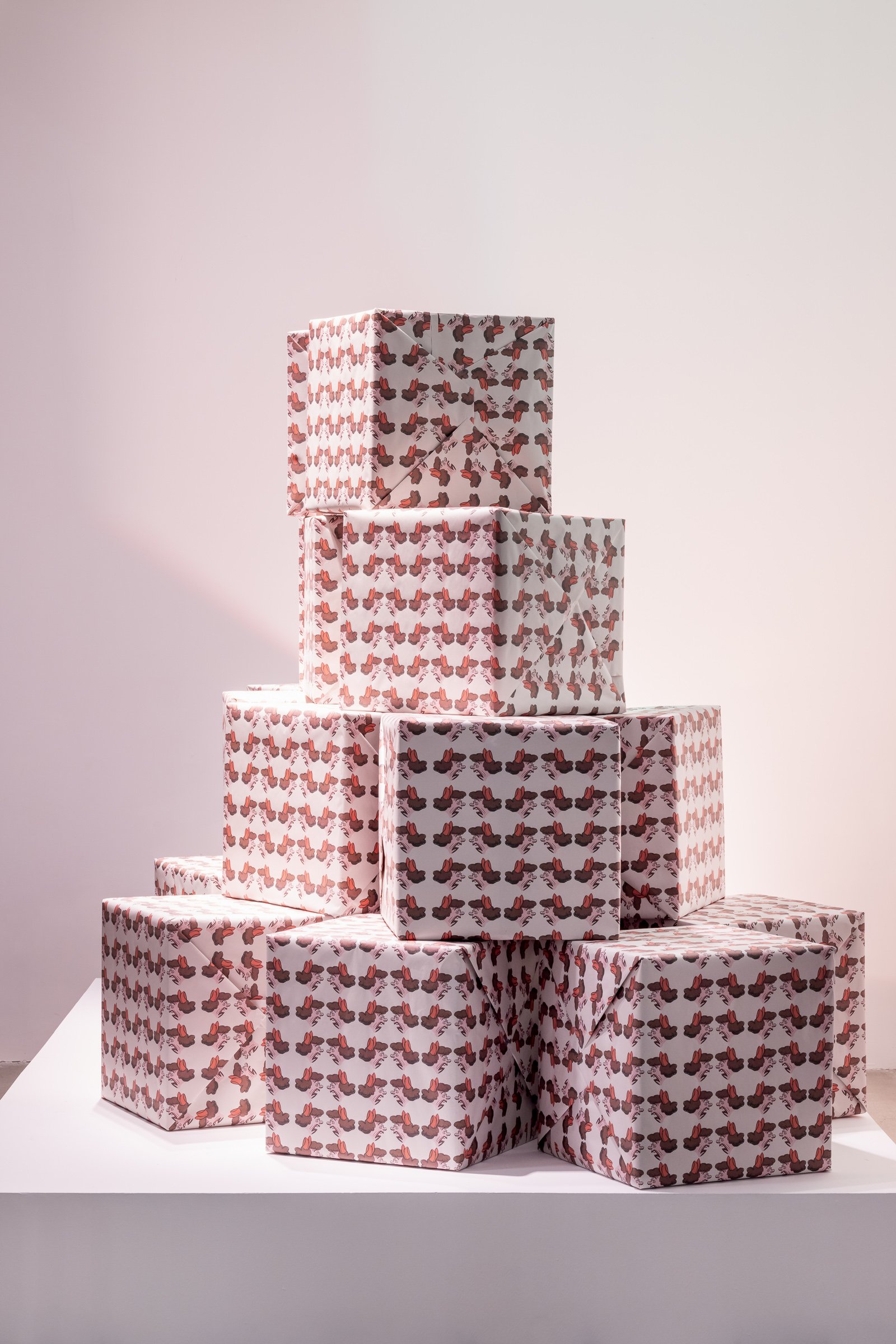 A pyramid of eight wrapped gift boxes with a caricature of a middle-aged woman, arranged against a white background.