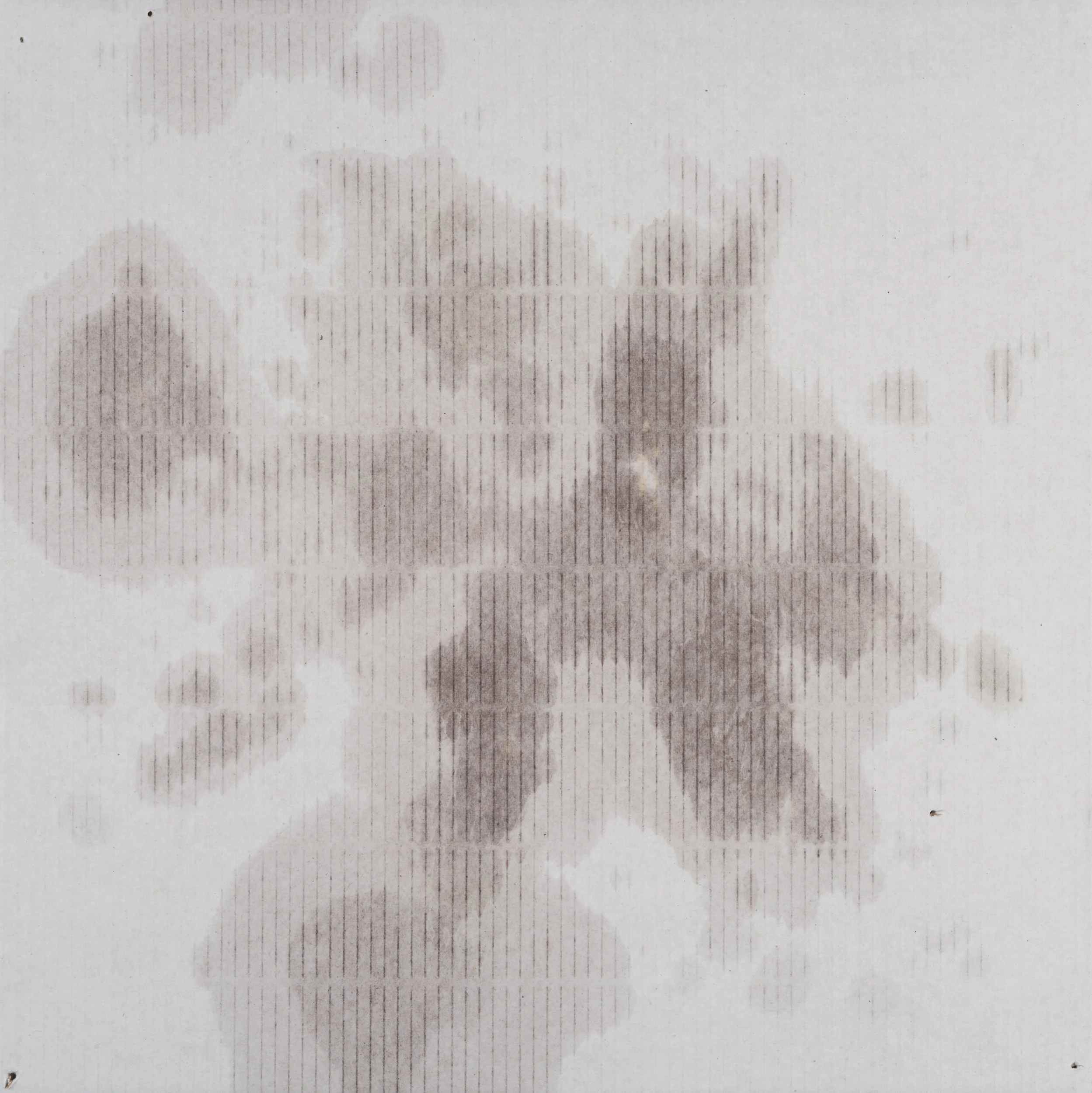 Photograph of paper with vertical lines and faint clouds, possibly a printed or textured surface.