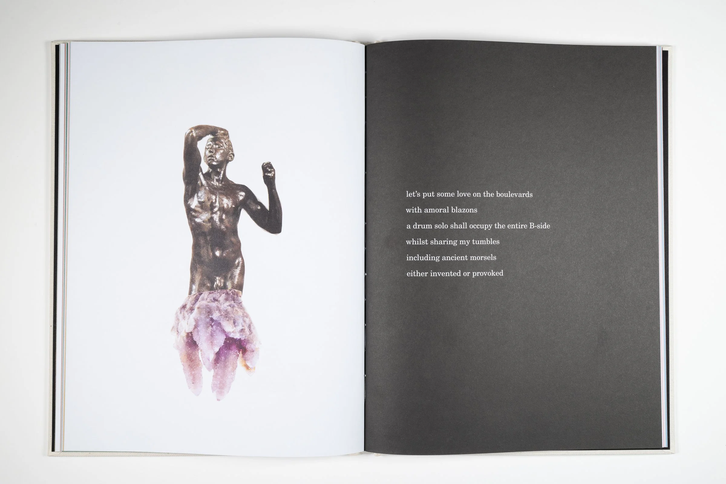 Open book showing a bronze statue of a woman with short hair, barefoot, and standing on a pinkish stone base, on the left page, and a dark grey page with white text on the right.