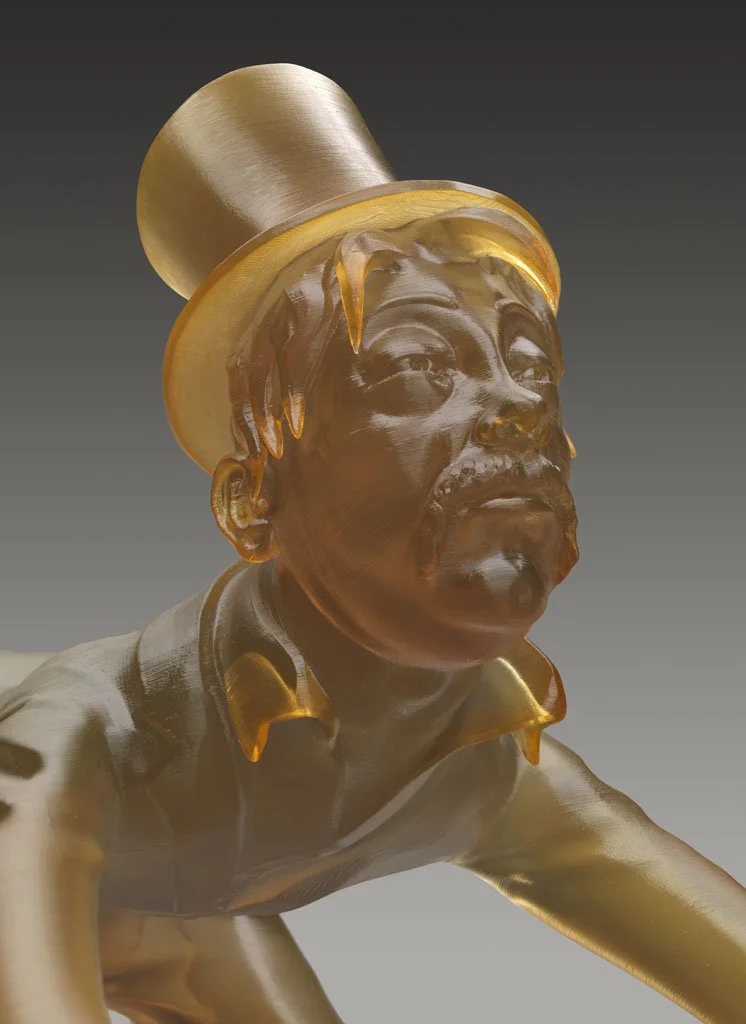 A sculpture of a man with glasses and a mustache wearing a tuxedo, with a top hat on his head.