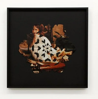 A framed artwork of Linda Blair from the film The Exorcist with cut into the shape of a snowflake s in a black frame