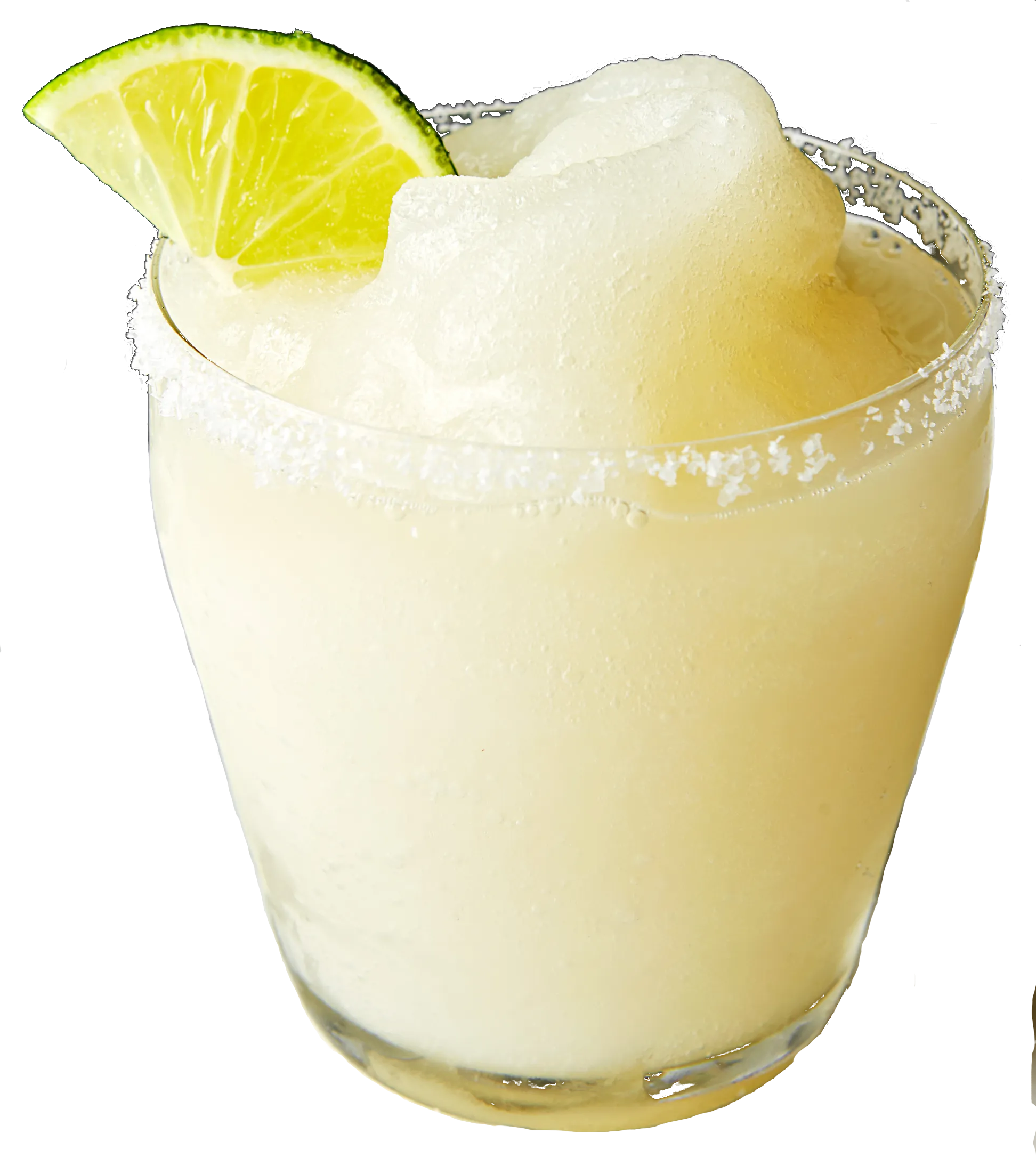 A glass of frozen margarita garnished with a lime wedge, with salted rim.