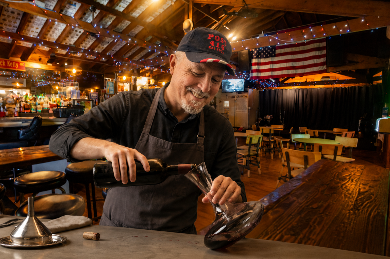 Our Post Commander as bartender, pouring wine into a glass in Club 416.