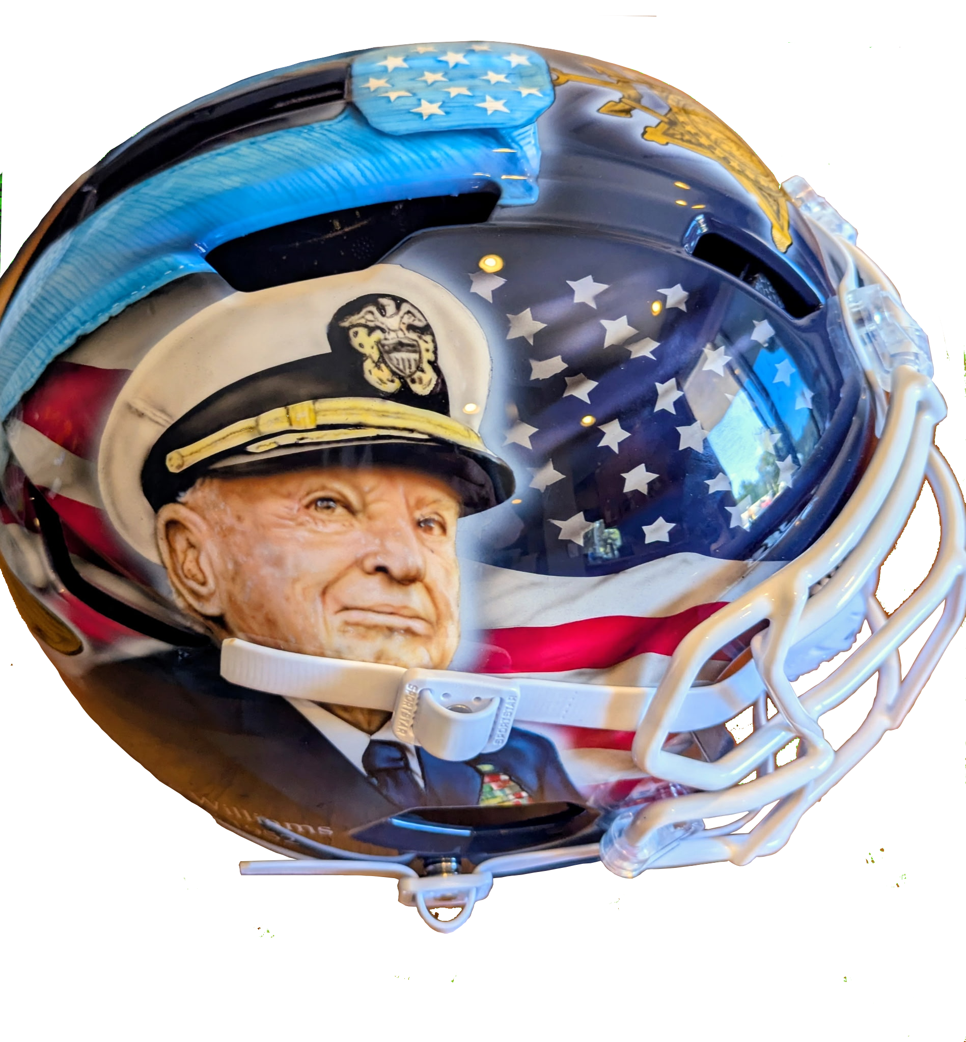 Close-up of a football helmet designed with an US flag theme, featuring stars and stripes, and a logo of a tiger wearing a football helmet.