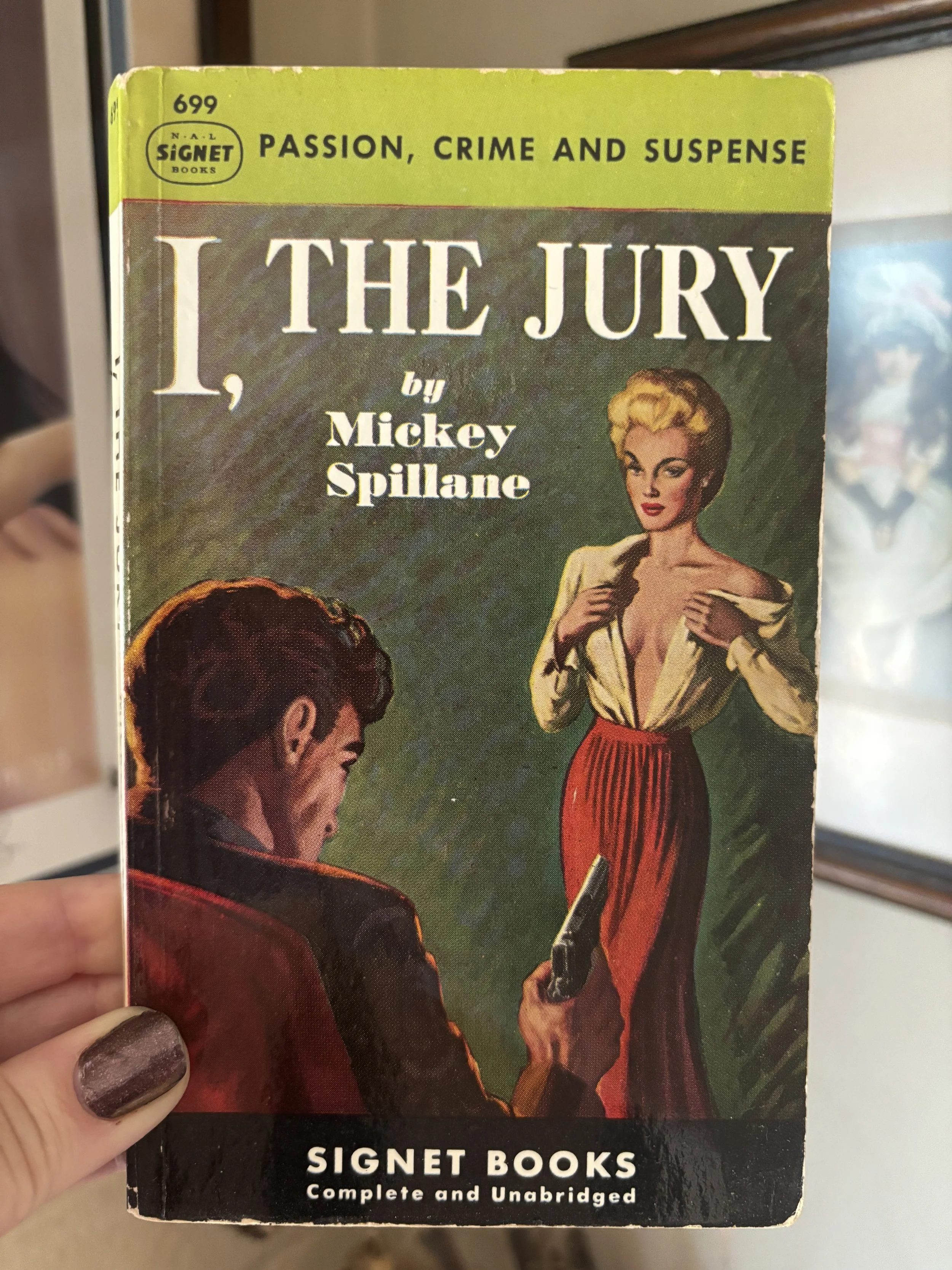 A vintage paperback book titled "I, The Jury" by Mickey Spillane, with a yellow top border reading "Passion, Crime and Suspense" and a black bottom band with the publisher logo "Signet Books" and the text "Complete and Unabridged." The cover features an illustration of a woman with blonde hair and a man with dark hair, set against a green background.