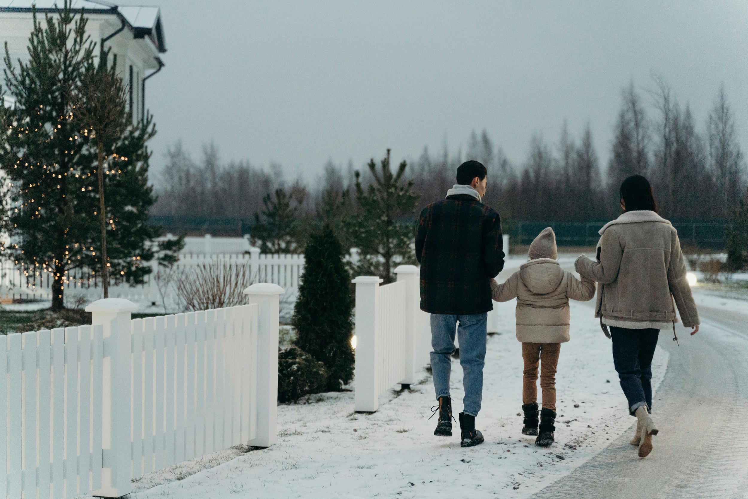 A family walking down a snowy road