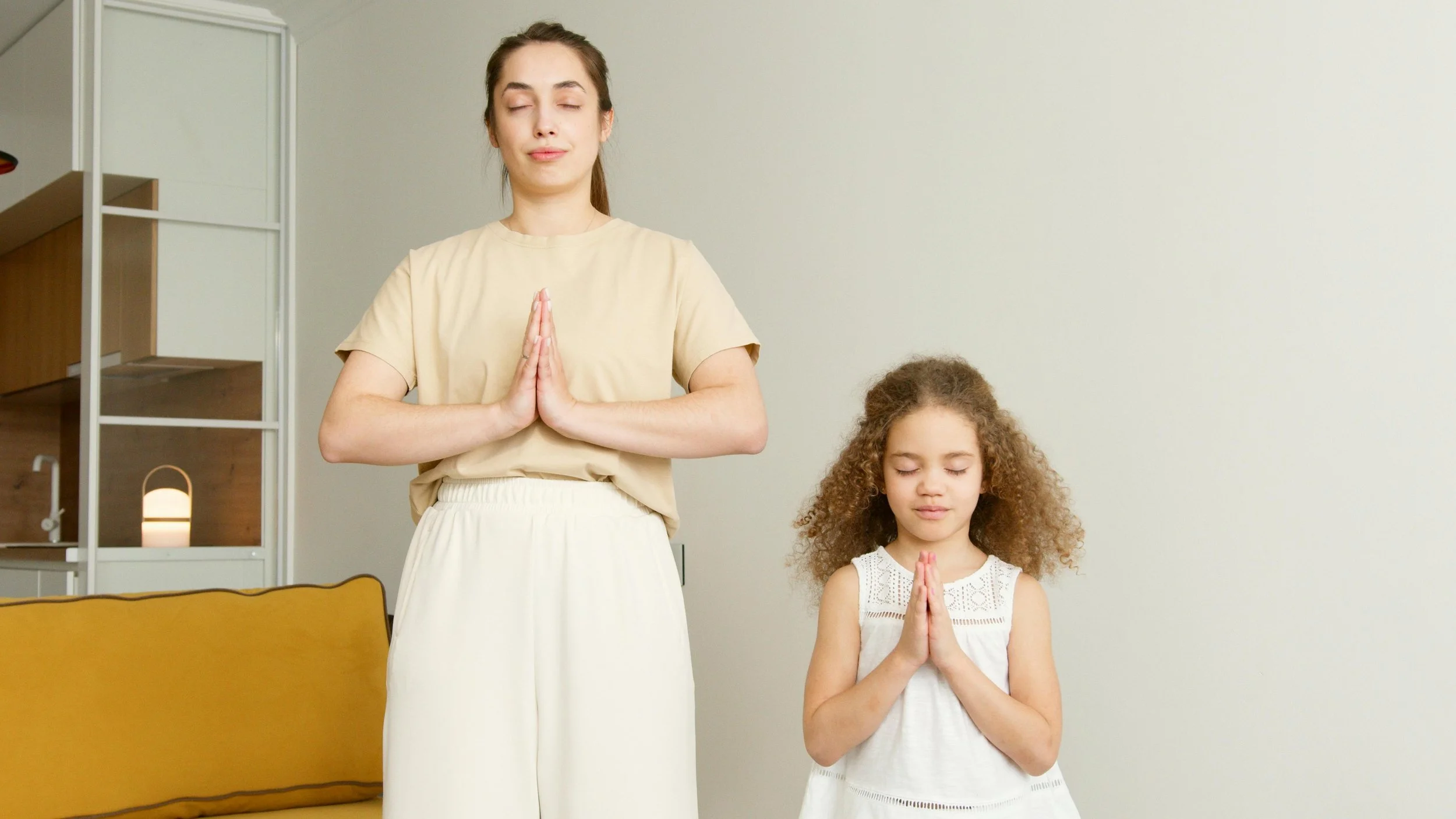 A parent and child do yoga together