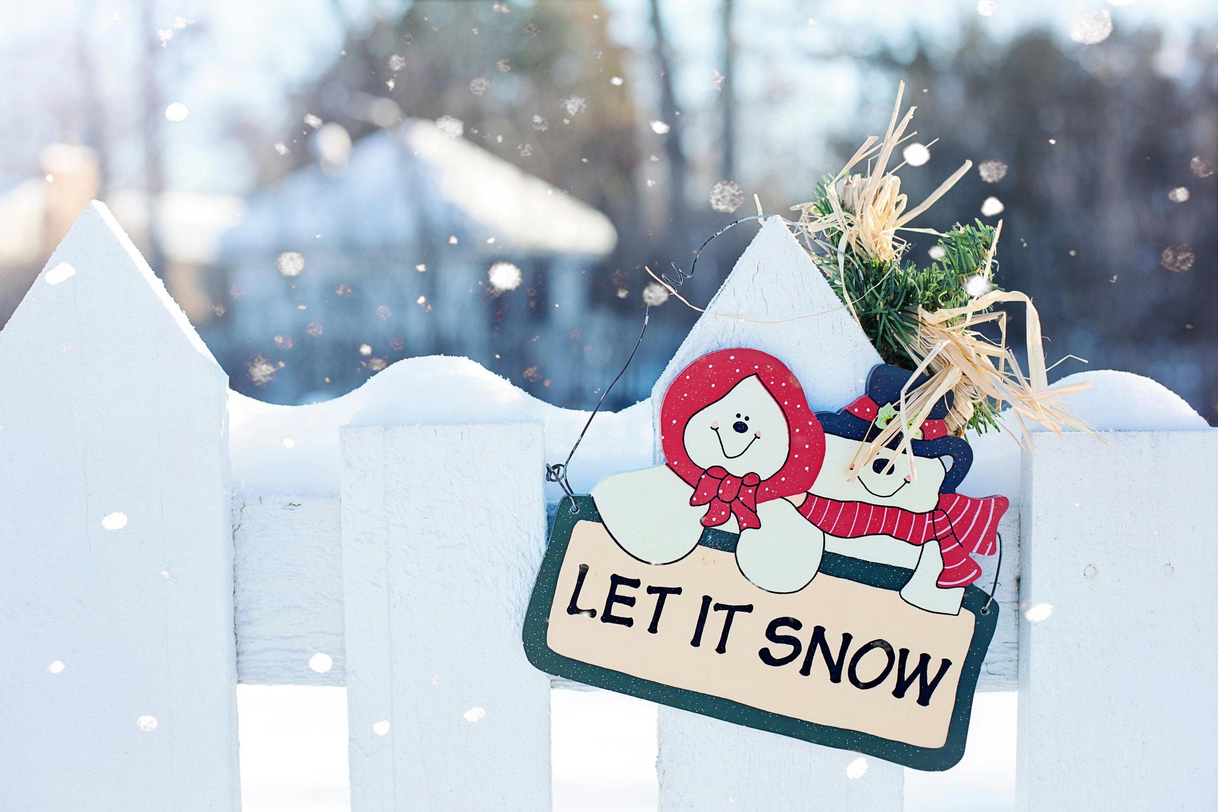 A sign in the snow that says 'let it snow'