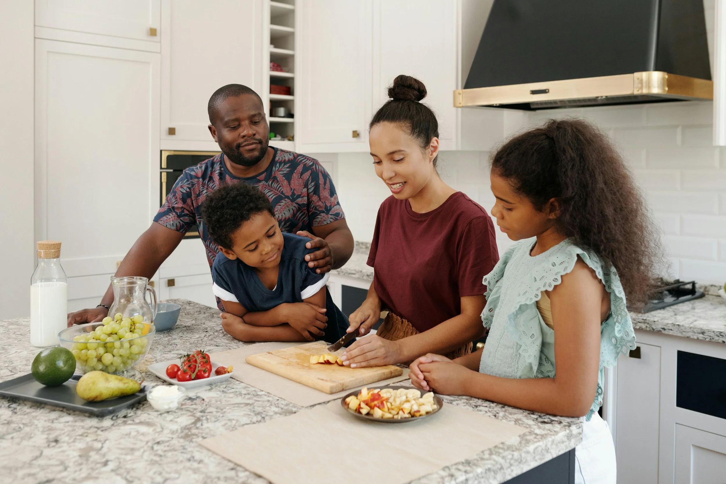 a family cooks together in the kitchen.