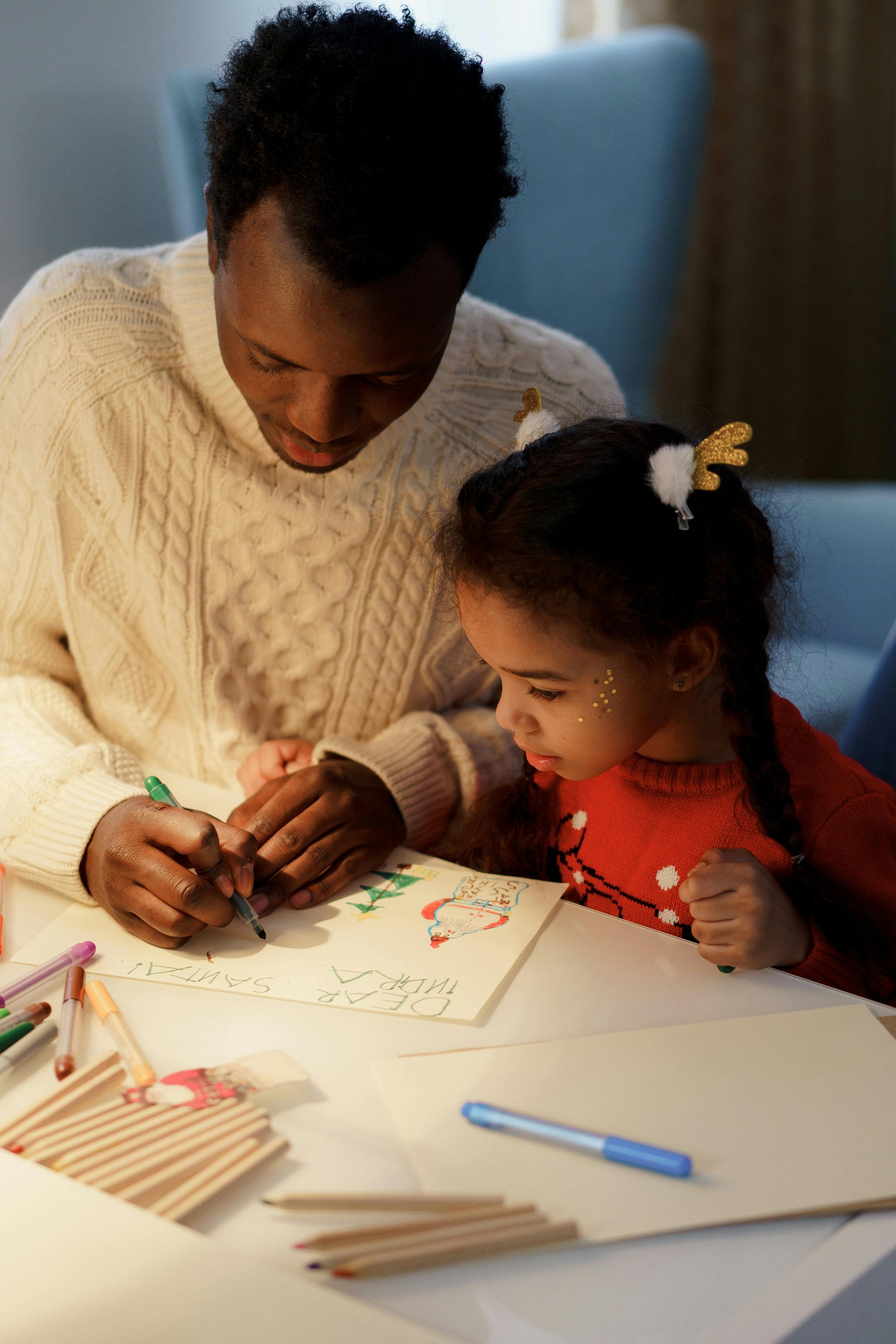 A parents making holiday crafts with their child