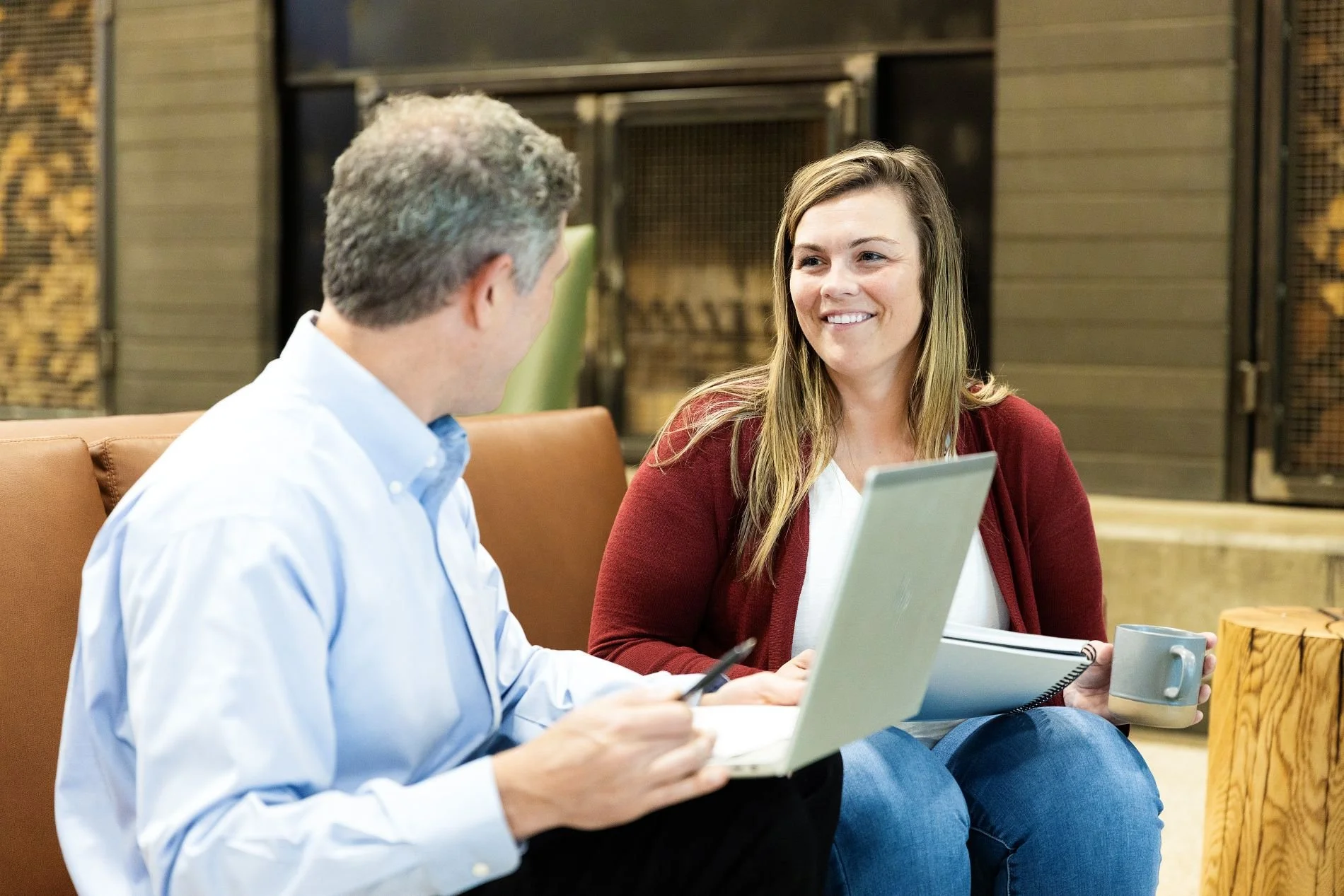 Randy Derenzo talking with female client who is smiling and holding a tablet.