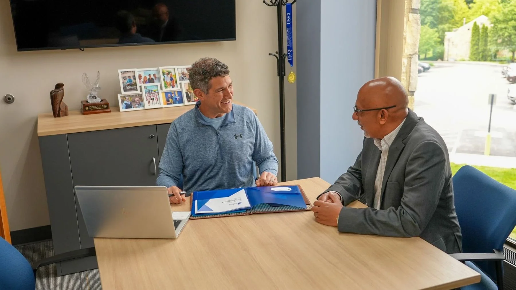 Randy Derenzo speaking and smiling with a male client