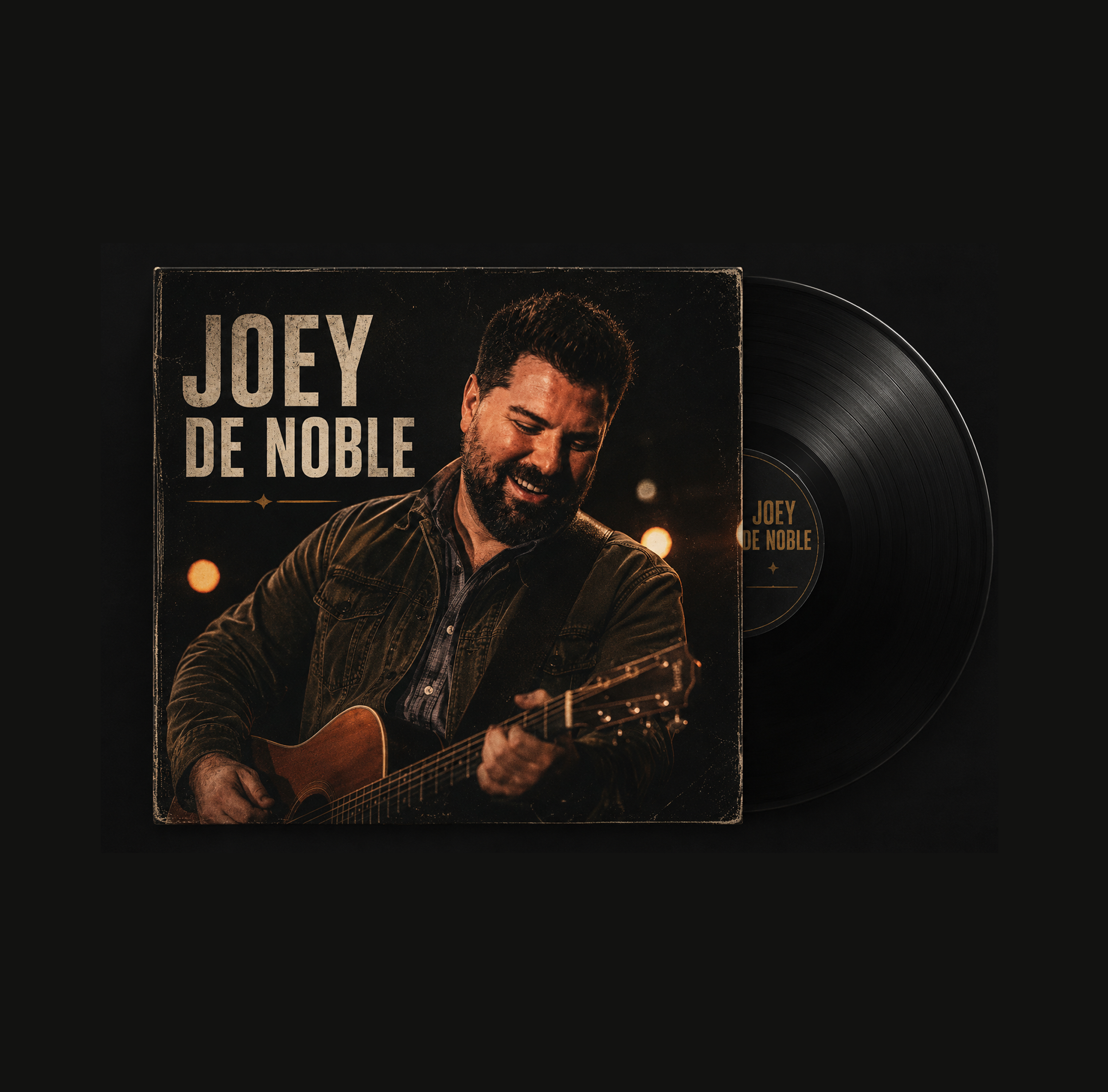 Close-up of a vinyl record and album cover with a photo of a man playing guitar, smiling, and text that reads 'Joey De Noble' on a black background.