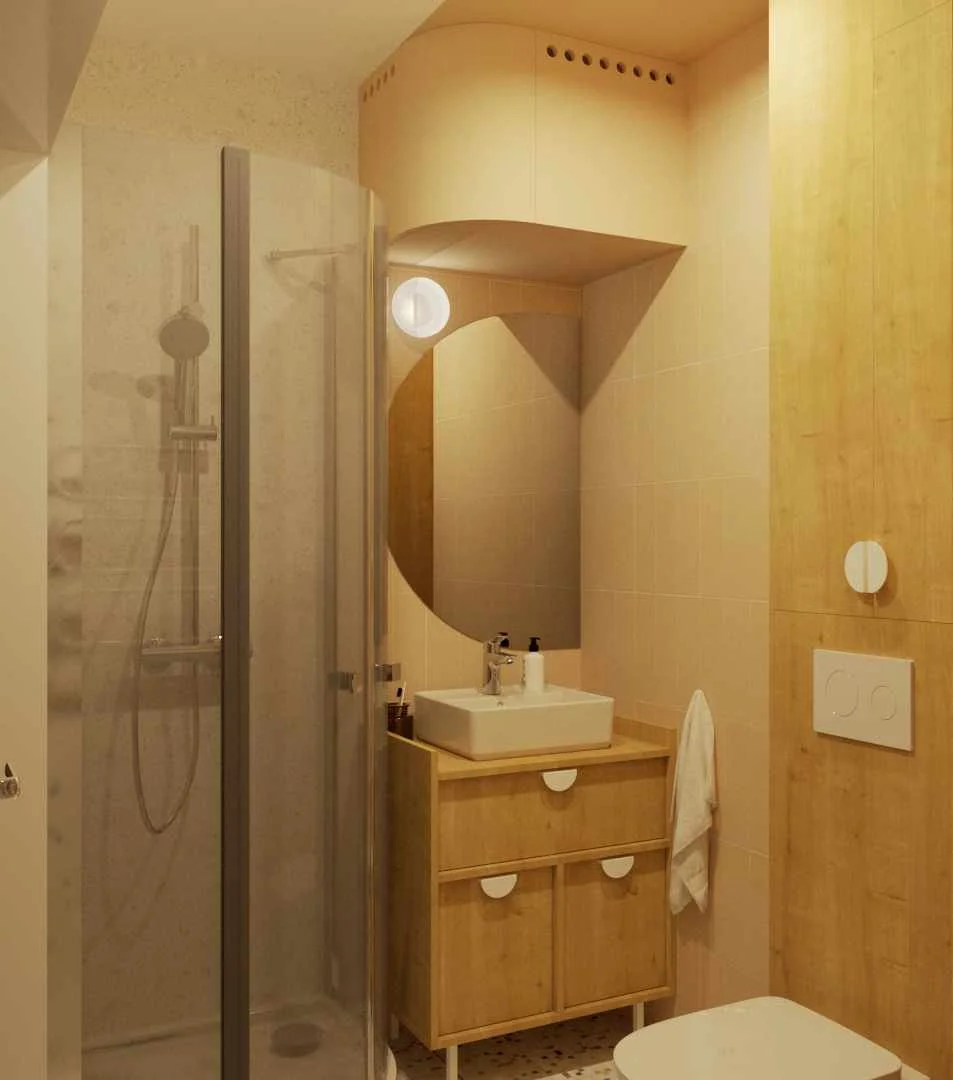 Small bathroom with a shower, a wooden vanity with a white sink, a mirror, a towel hanging on the wall, and a toilet.