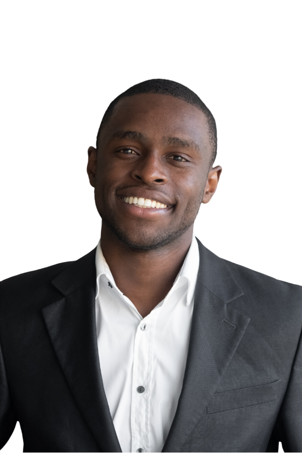 A smiling man in a black suit jacket and white shirt, looking at the camera.