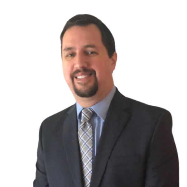 A professional man in a suit with a plaid tie, smiling, with a plain black background.
