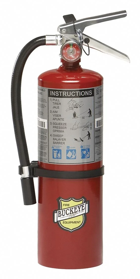 A red fire extinguisher with instructions label on it, a hose on the side, and a pressure gauge on top, attached to a black mounting bracket.