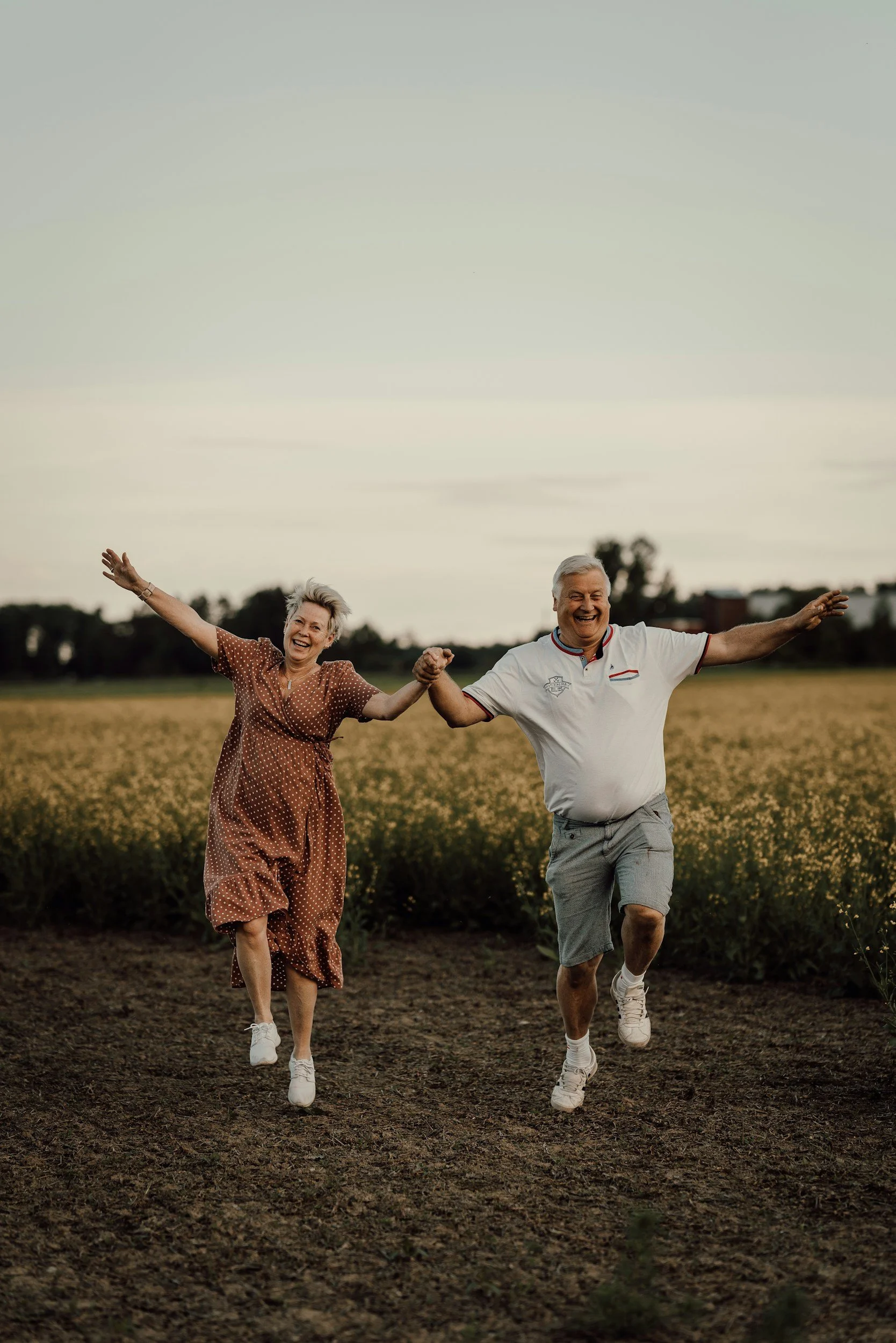 Retired couple holding hands and skipping