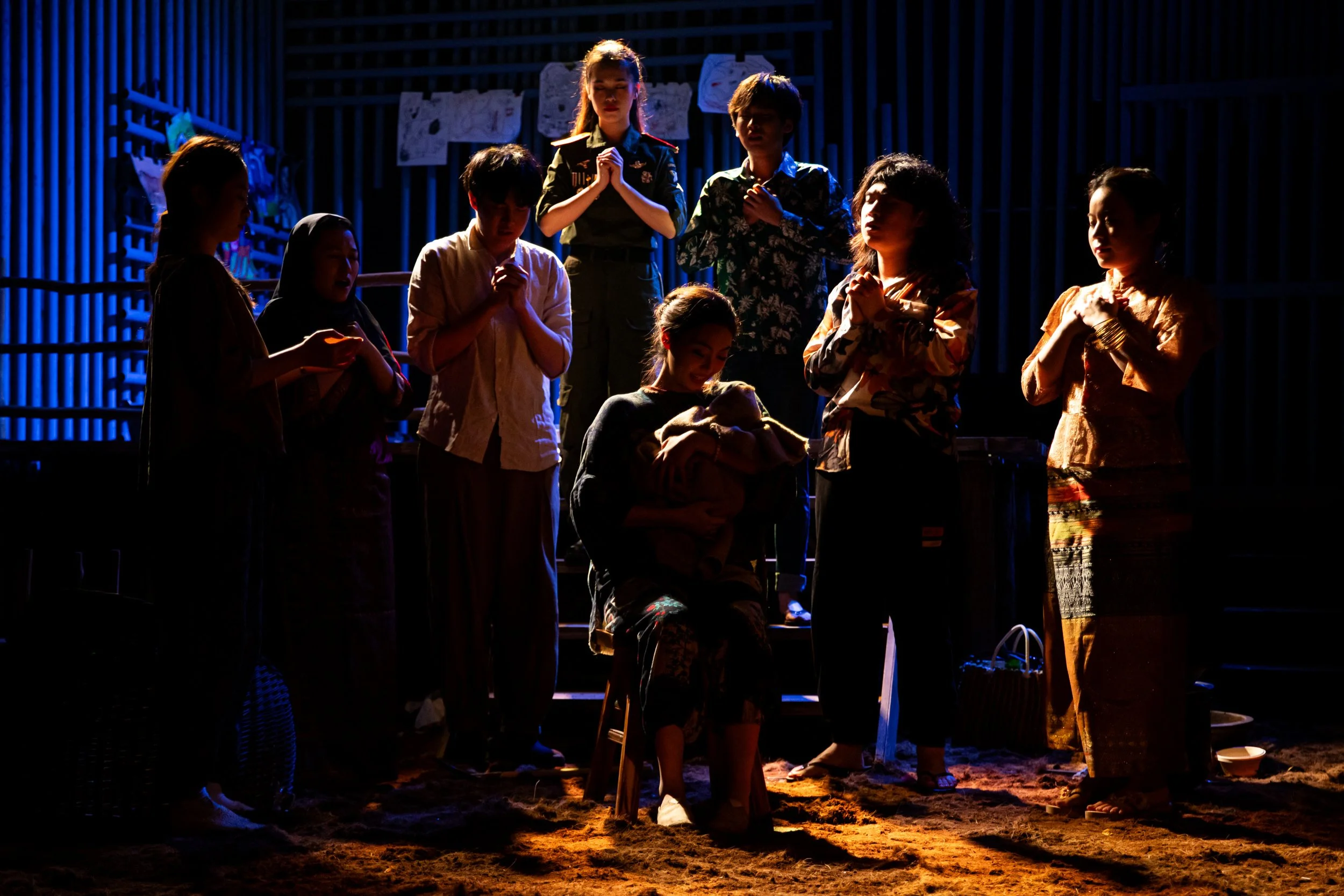 Group of children participating in a nativity scene or Play, with some prayerful or respectful poses.