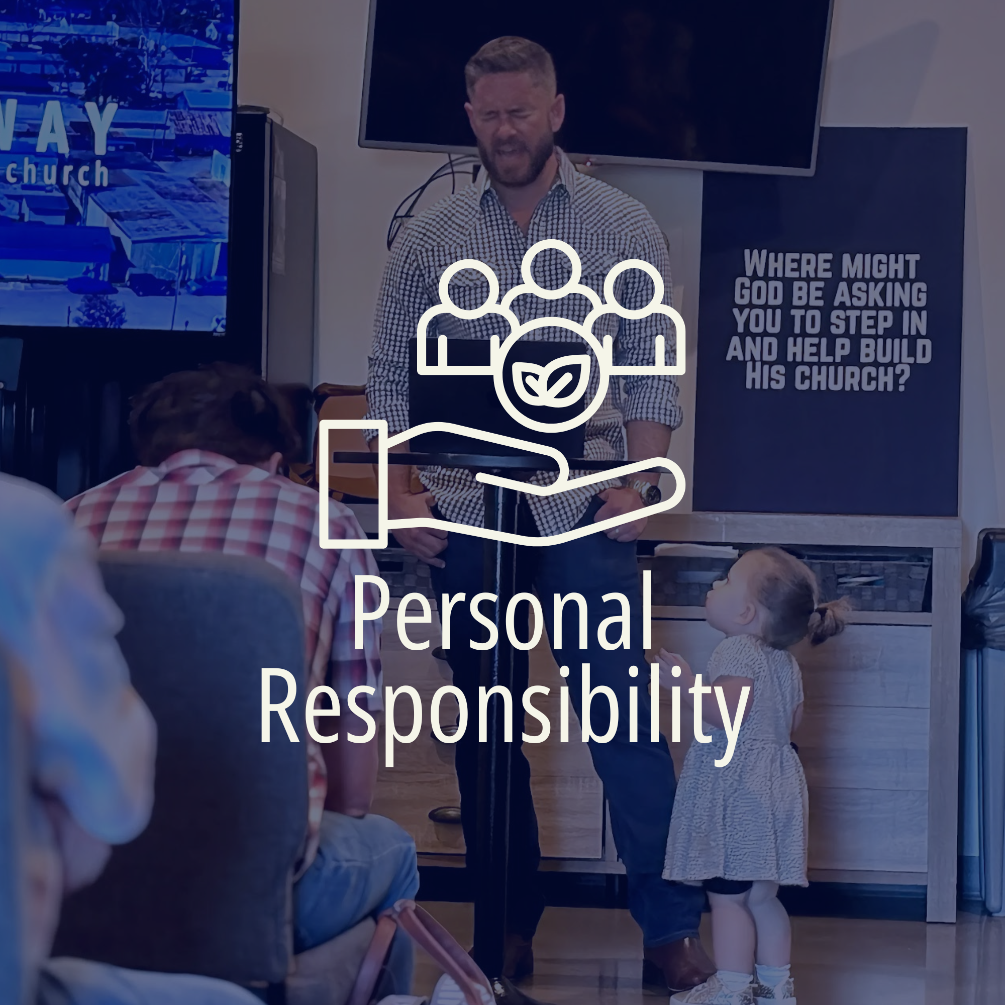 A man with a beard and checkered shirt standing in front of a screen and a sign that reads, "Where might God be asking you to step in and help build his church?" inside a room with people seated facing him.