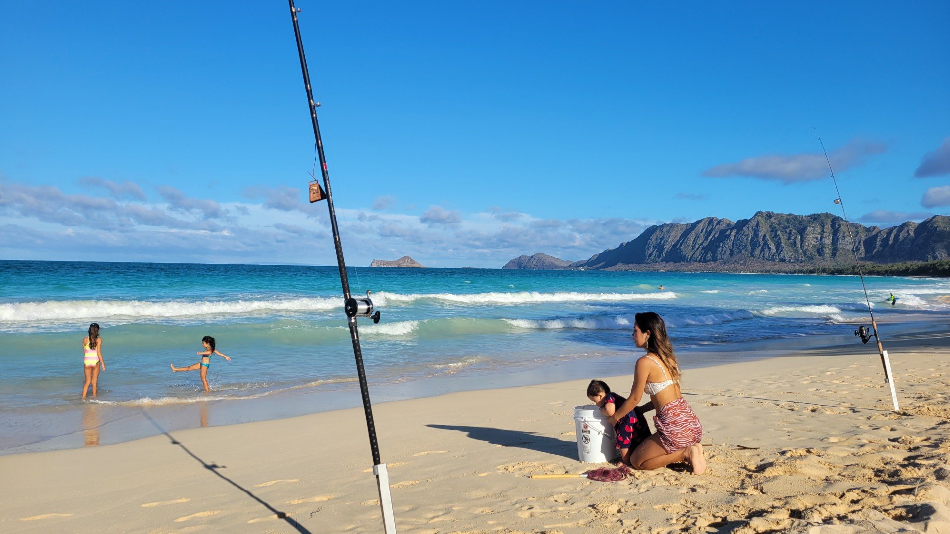 family fishing on beach in Hawaii