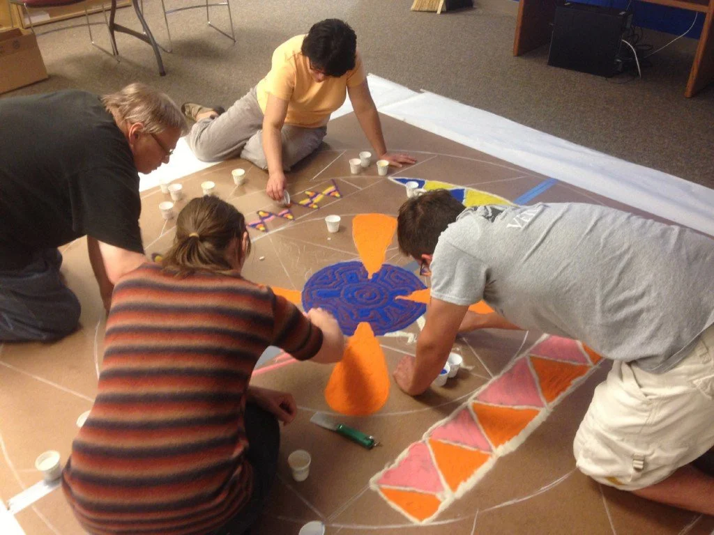 Veterans make sand painting.