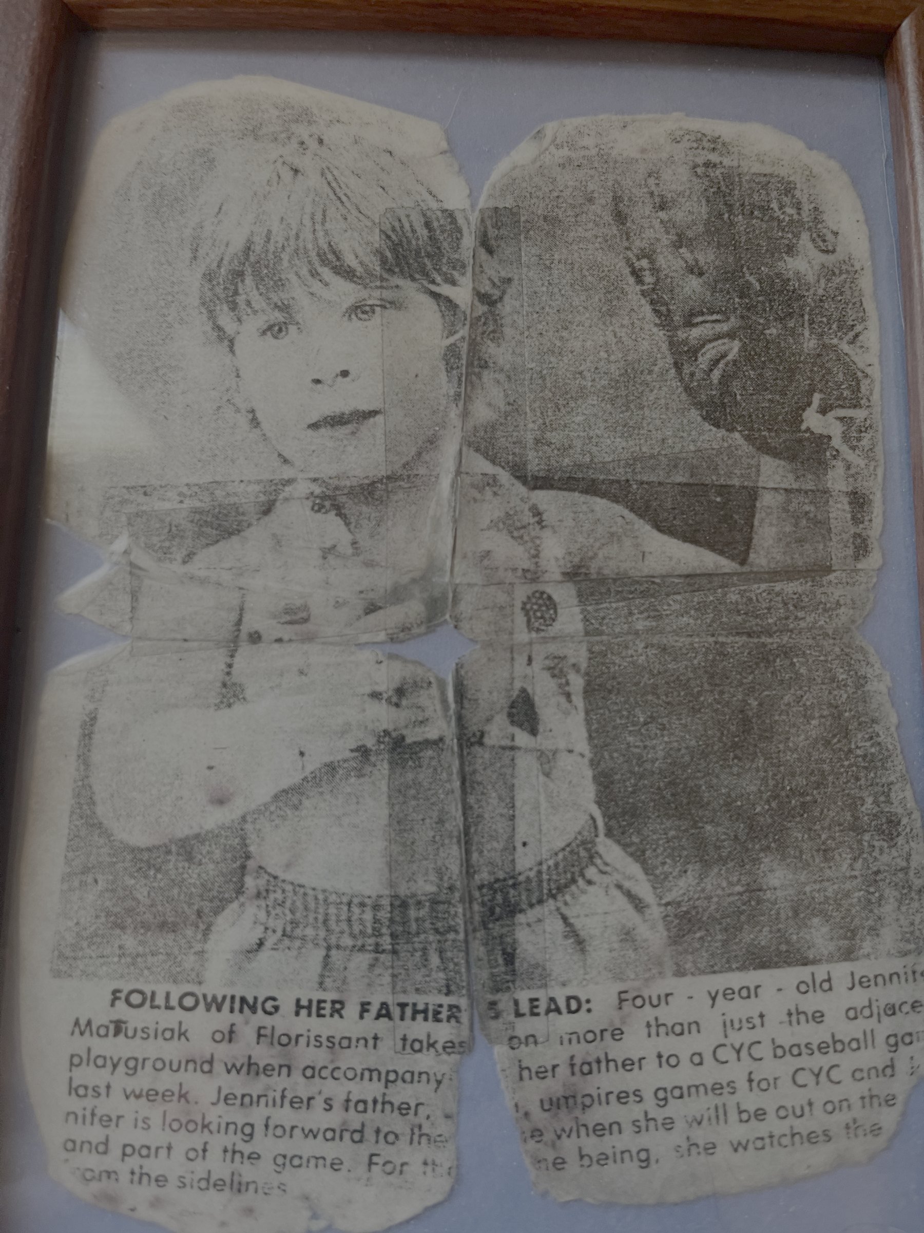 Newspaper clipping headlined Following Her Father's Lead, about a young Jen going along to the ballfield with her father.