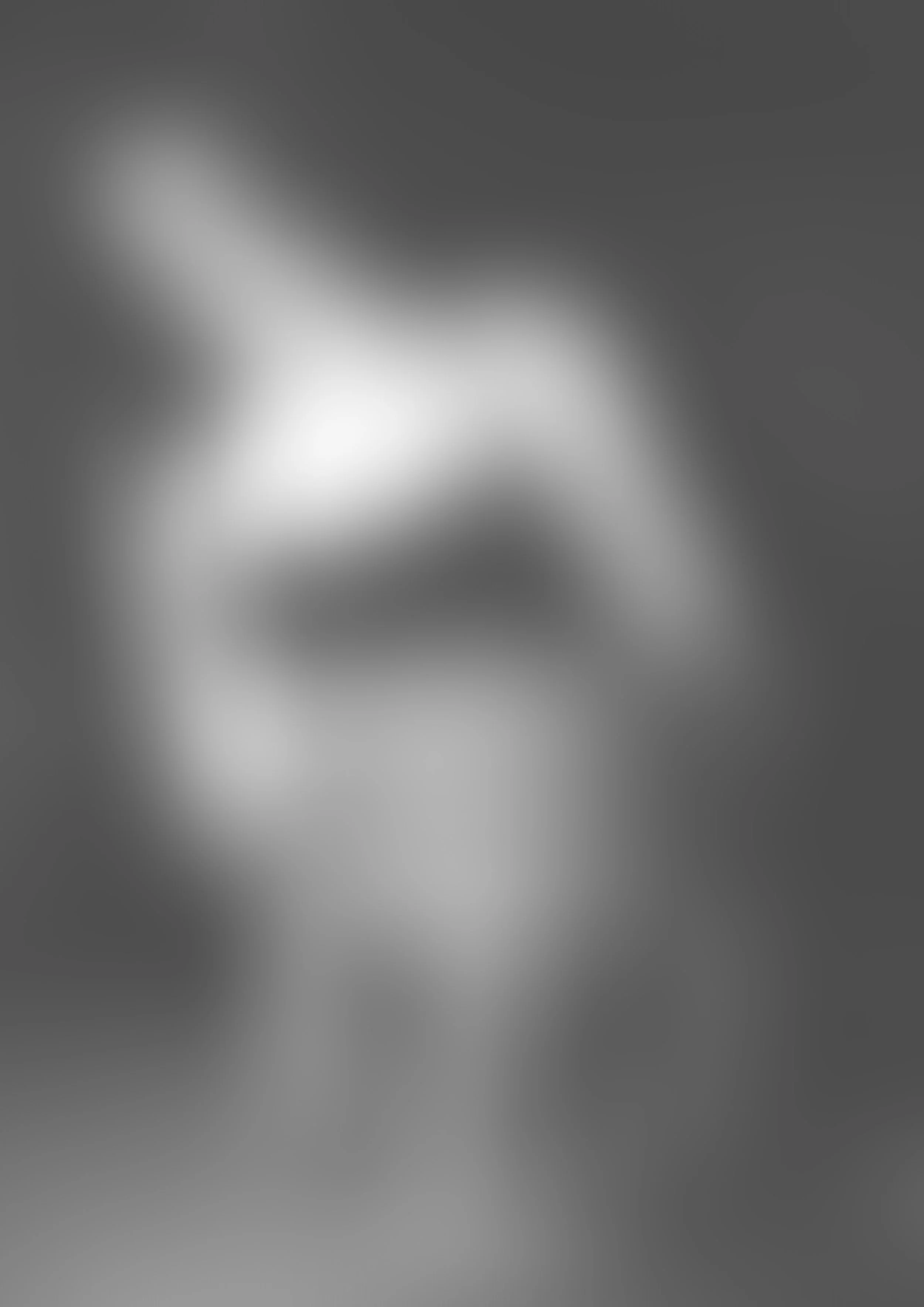 The image is blurred and in grayscale, making it difficult to identify specific objects or details.