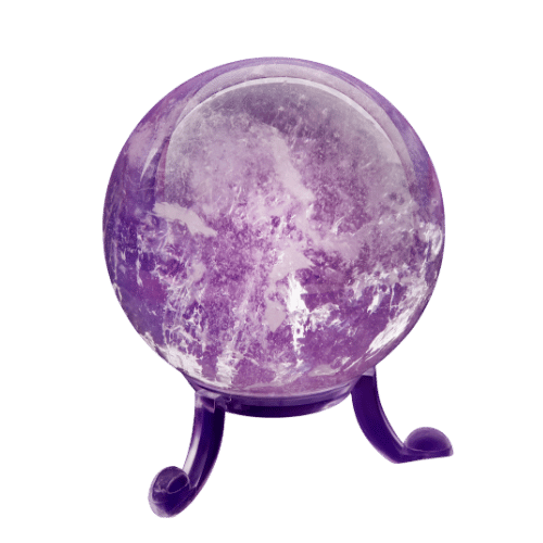 A moon lamp designed to look like the moon, with a purple hue, mounted on three small legs.