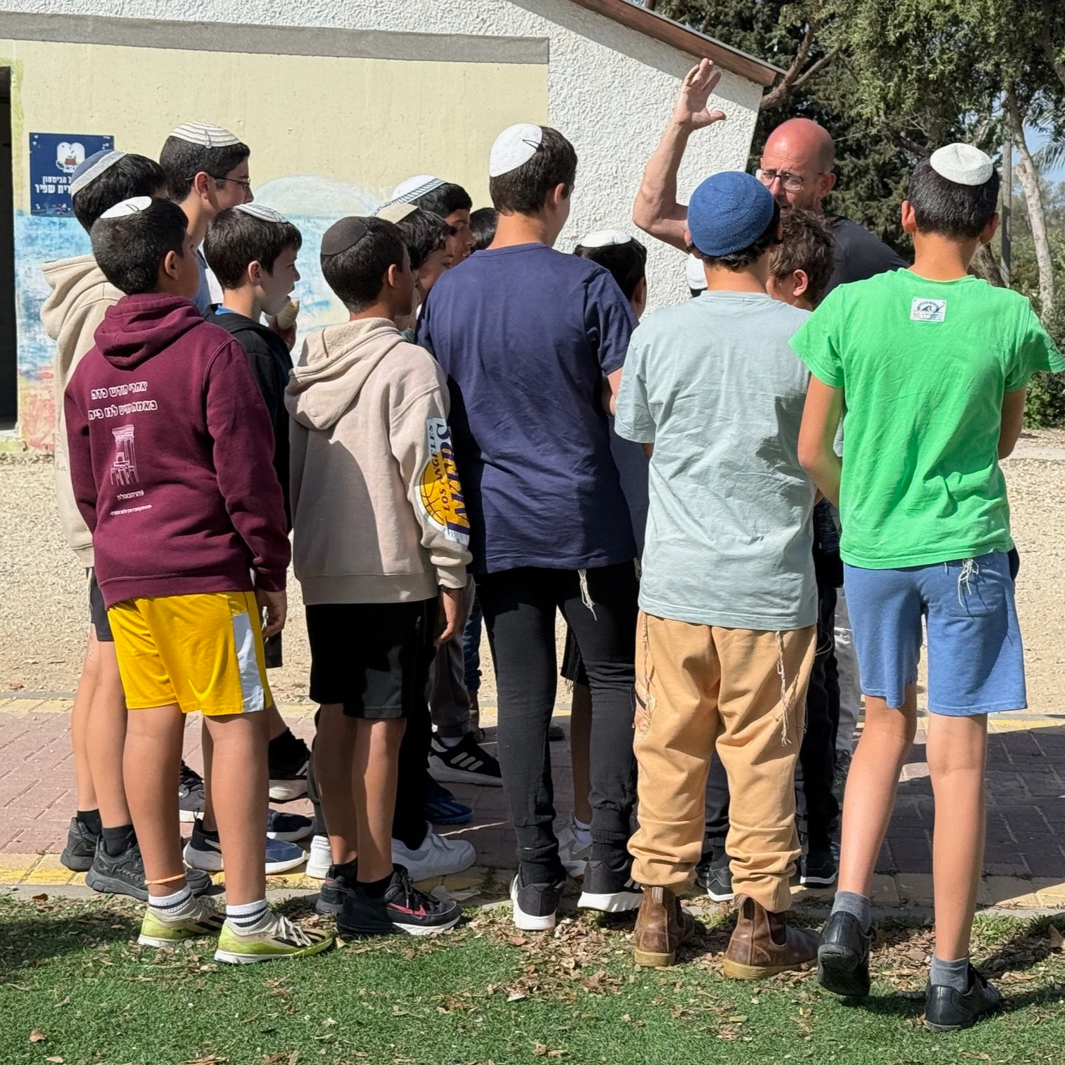 Col. Erez Eshel, founder of Ein-Prat Academies, surrounded by Israeli youth.
