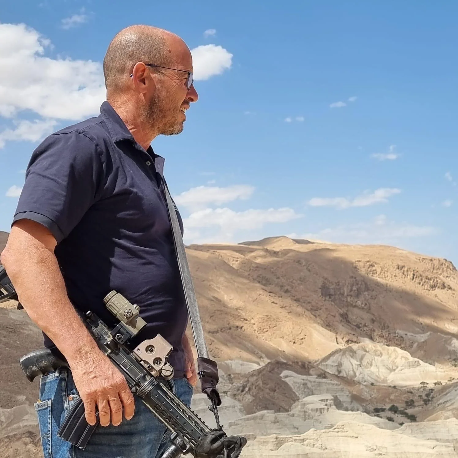 Col. Erez Eshel the subject of The Prophet documentary standing on Mount Aharon with an automatic rifle.
