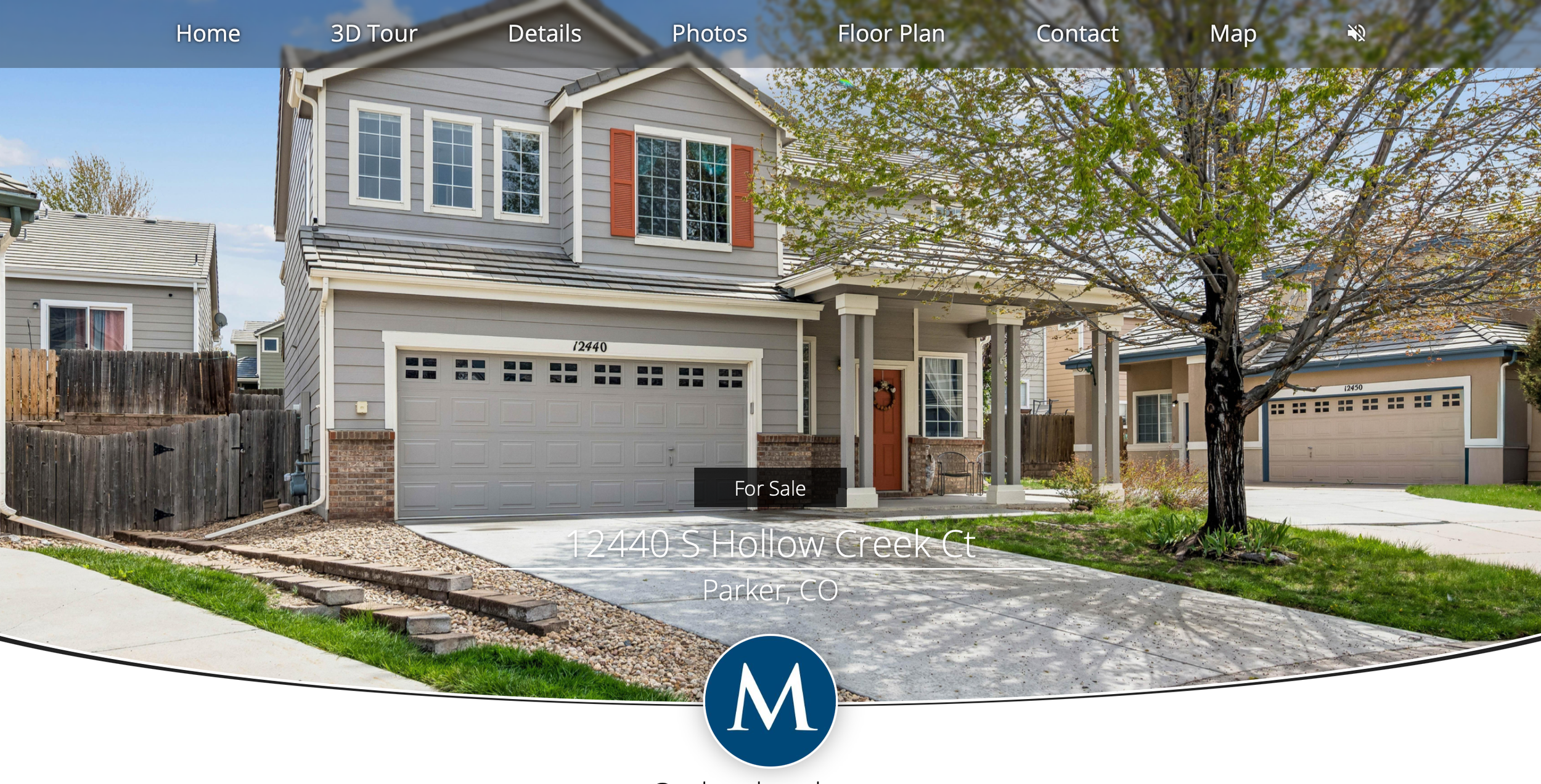 Front view of a two-story house with gray siding, a garage door, and a porch with an orange door, situated on S Hollow Creek Ct in Parker, Colorado, for sale. There is a large tree with green leaves in the front yard and neighboring houses visible in the background.