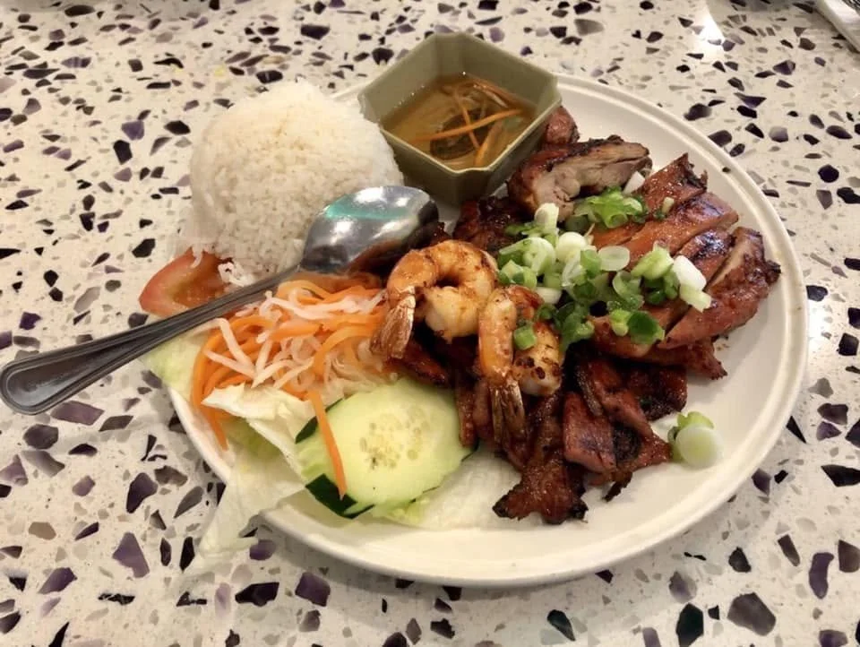 Plate of Asian grilled meats with rice, vegetables, and broth