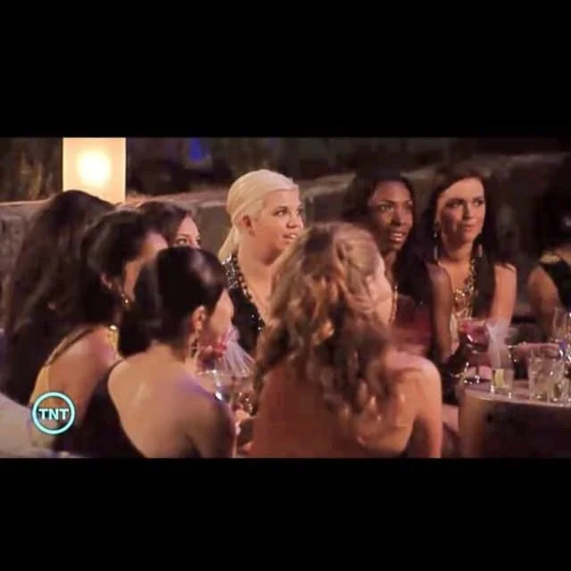 Group of women sitting at a dinner table during a social event or party.