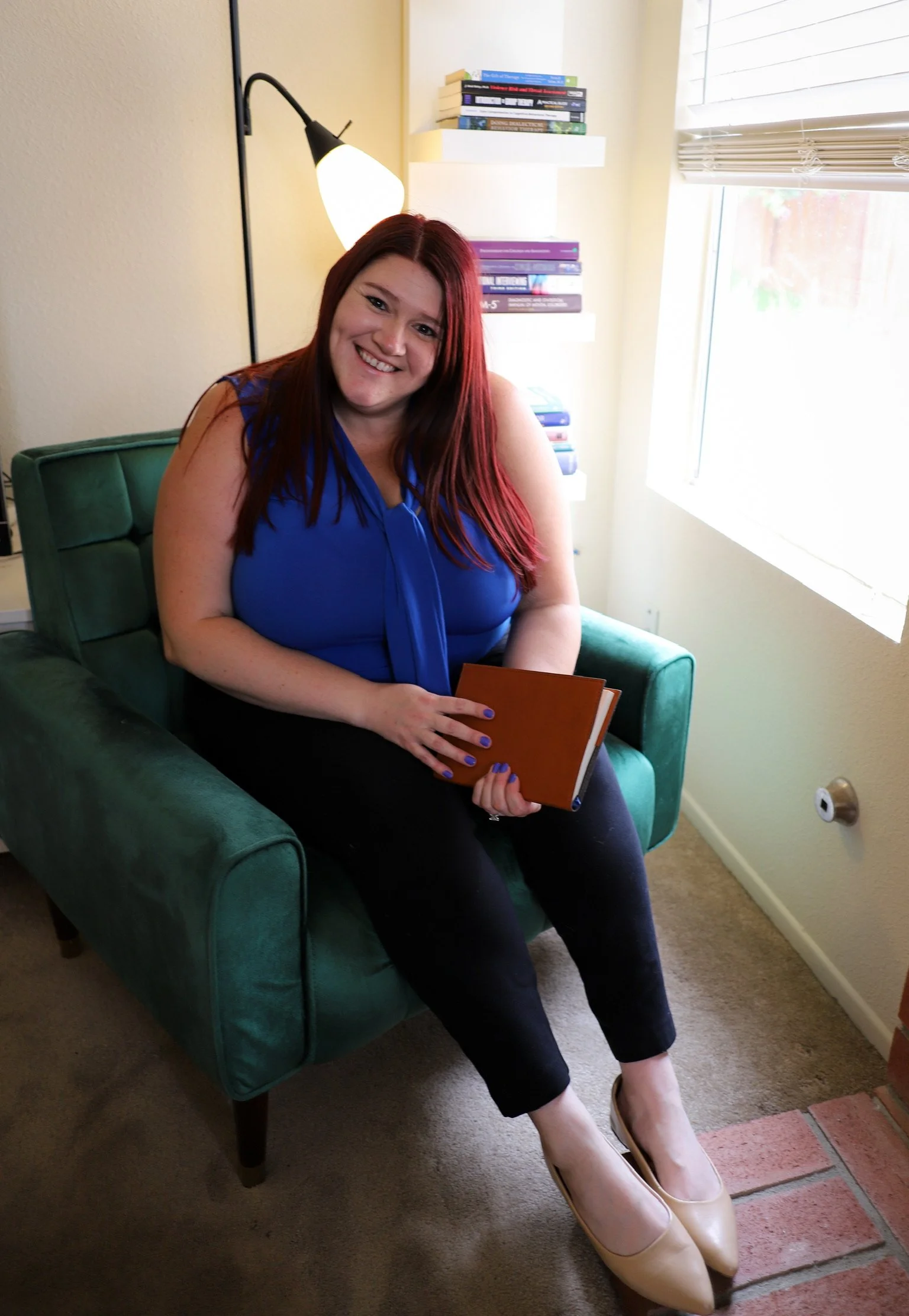 Psychologist welcoming clients into a calm, supportive therapy environment.