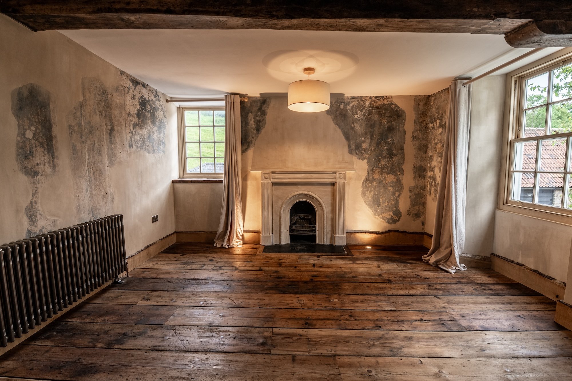 Elegant heritage bedroom at From Stone To Sky film estate featuring exposed beams, original timber floors and authentic period interiors for film and television productions.