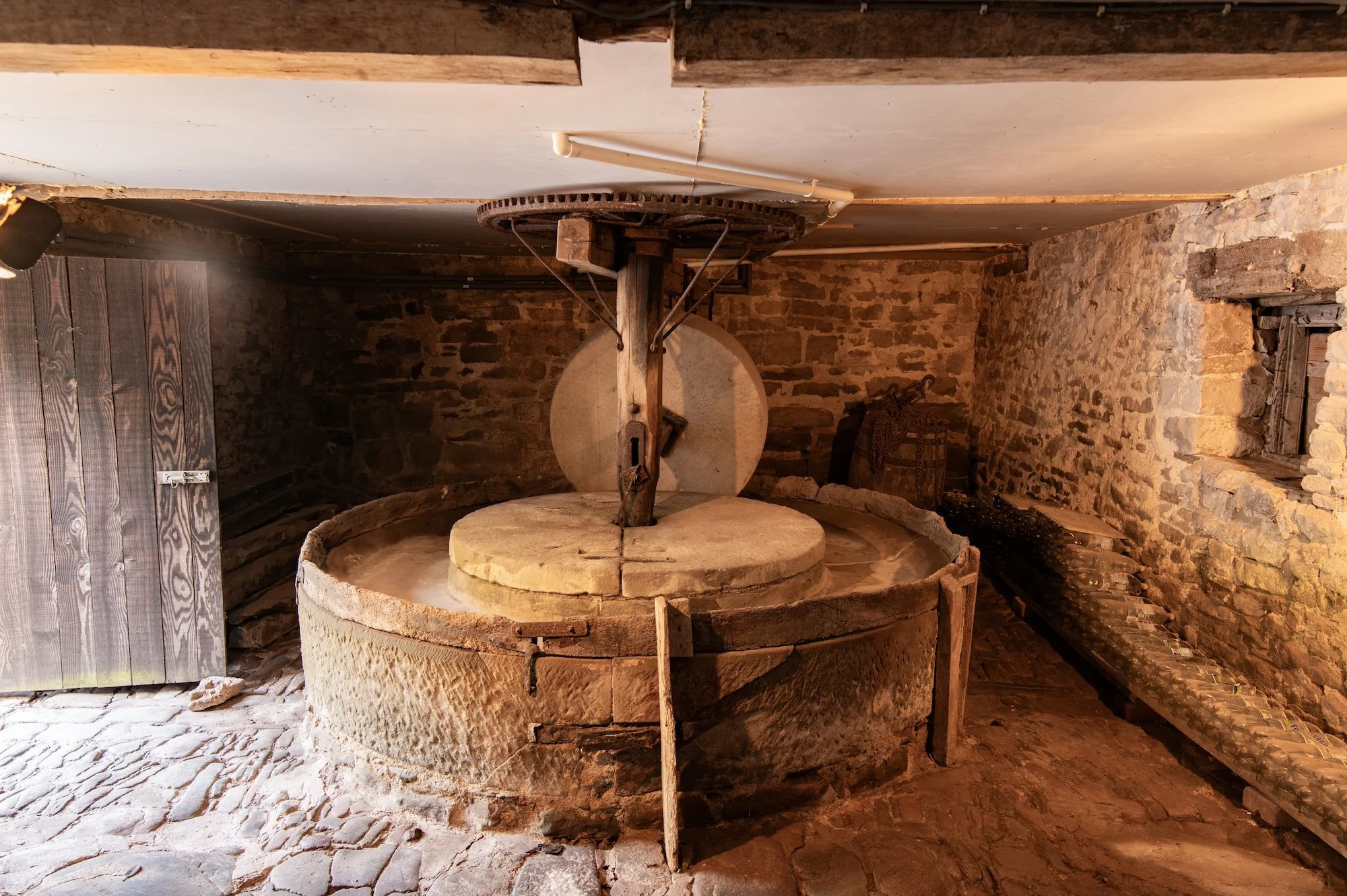 Historic cider press at From Stone to Sky film estate featuring original machinery, weathered stone interiors and traditional agricultural heritage.