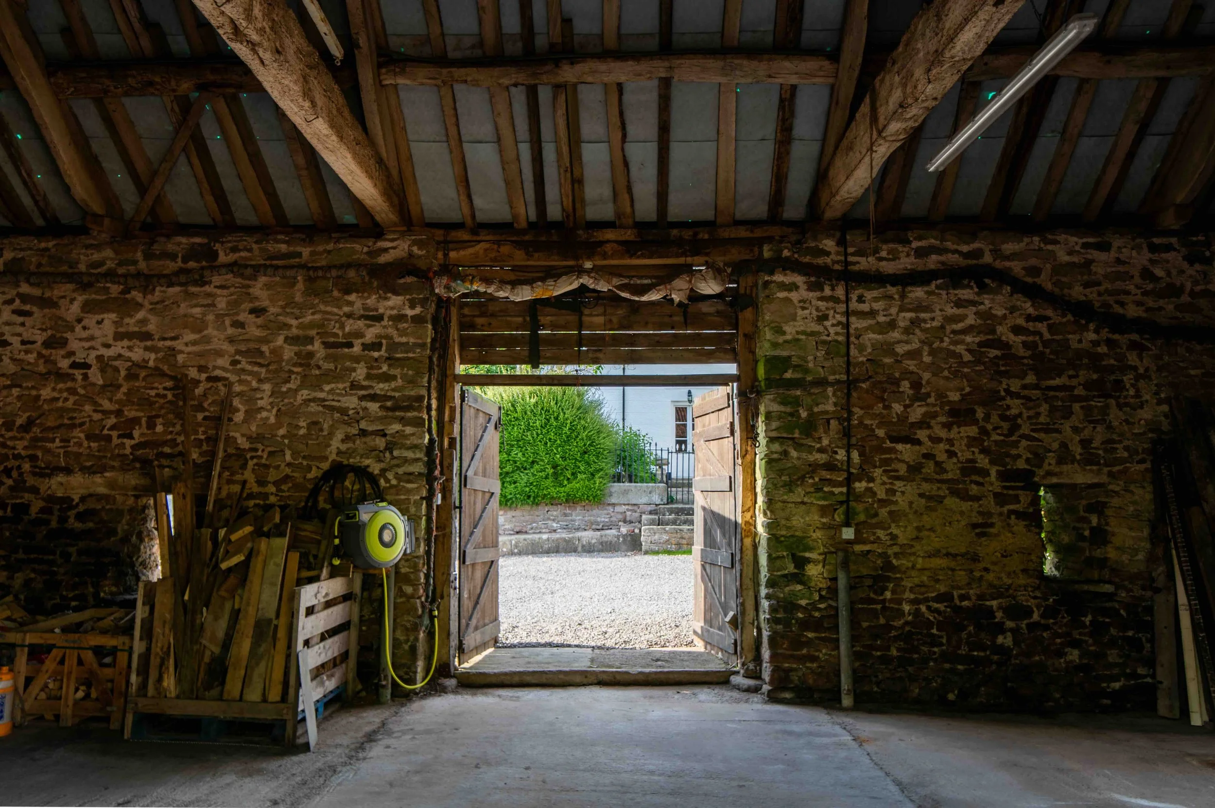 Farmstead-side entrance to the Art Department Build Box with stone walls and wide access opening.