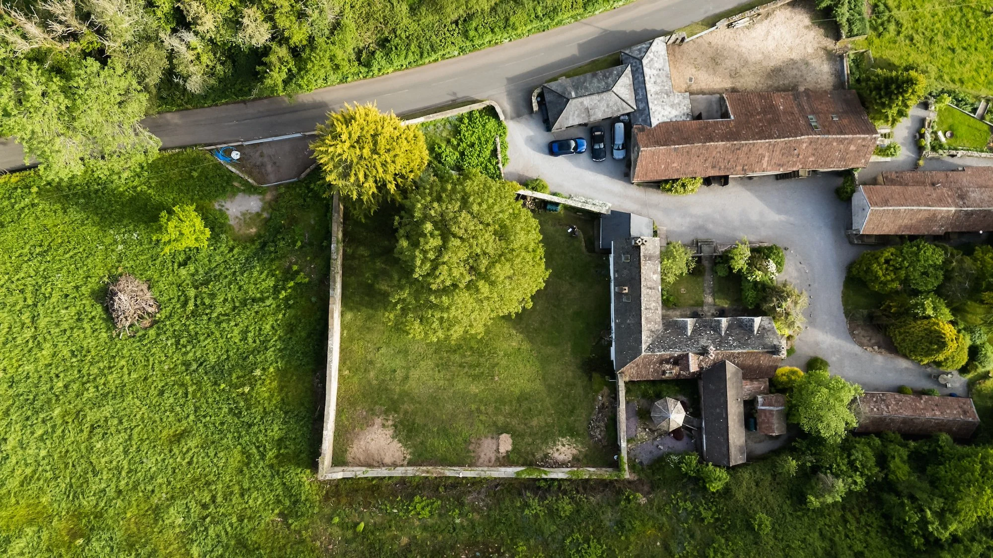 Aerial view of the enclosed walled garden film location at From Stone to Sky, showing a private self-contained period garden surrounded by historic stone walls.