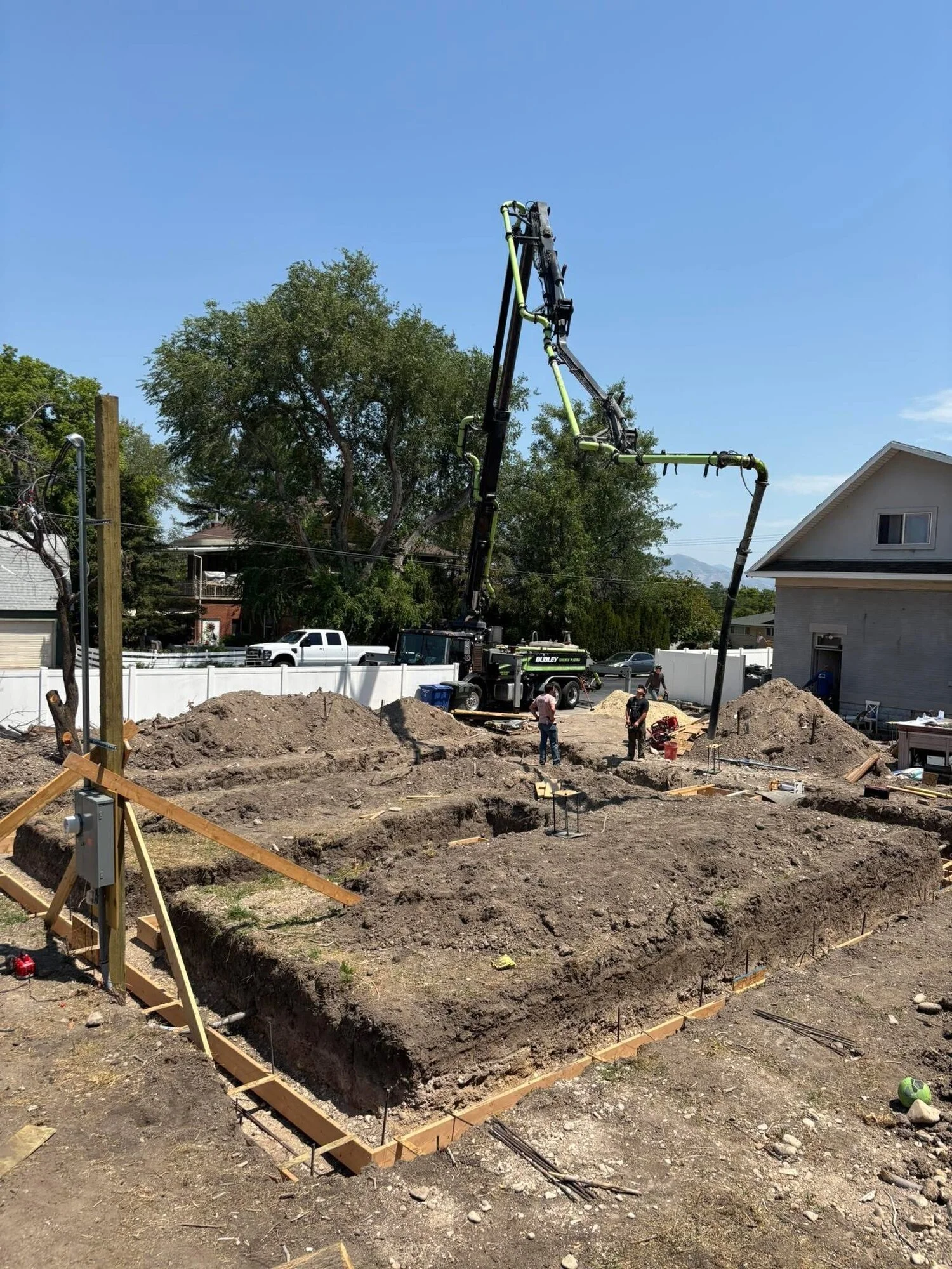 Concrete pump truck placing footings and foundation walls on a new residential build in Utah