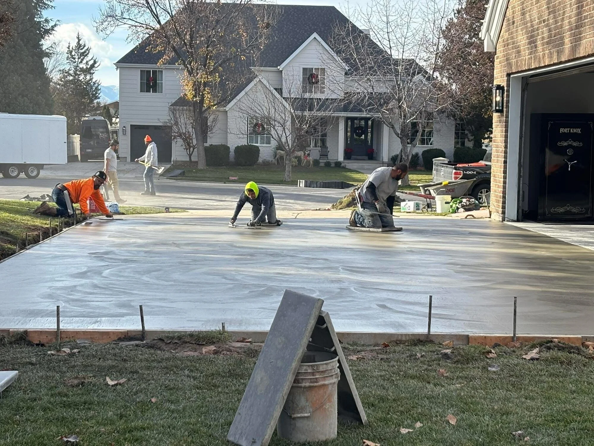 Zion Concrete Specialists crew power-troweling a freshly poured residential driveway in the Salt Lake Valley, Utah